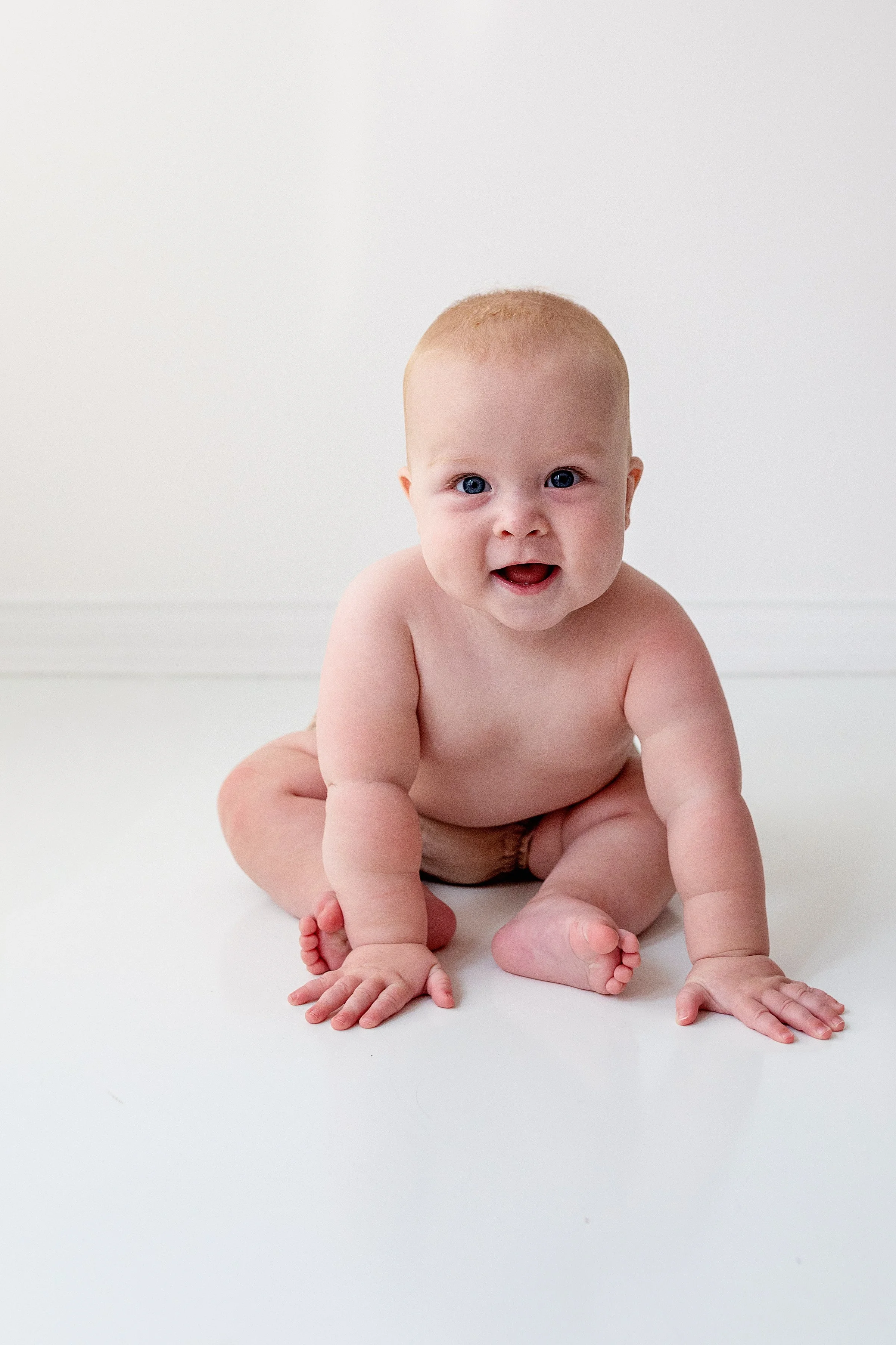 Smiling Baby  with red hair looking at camera