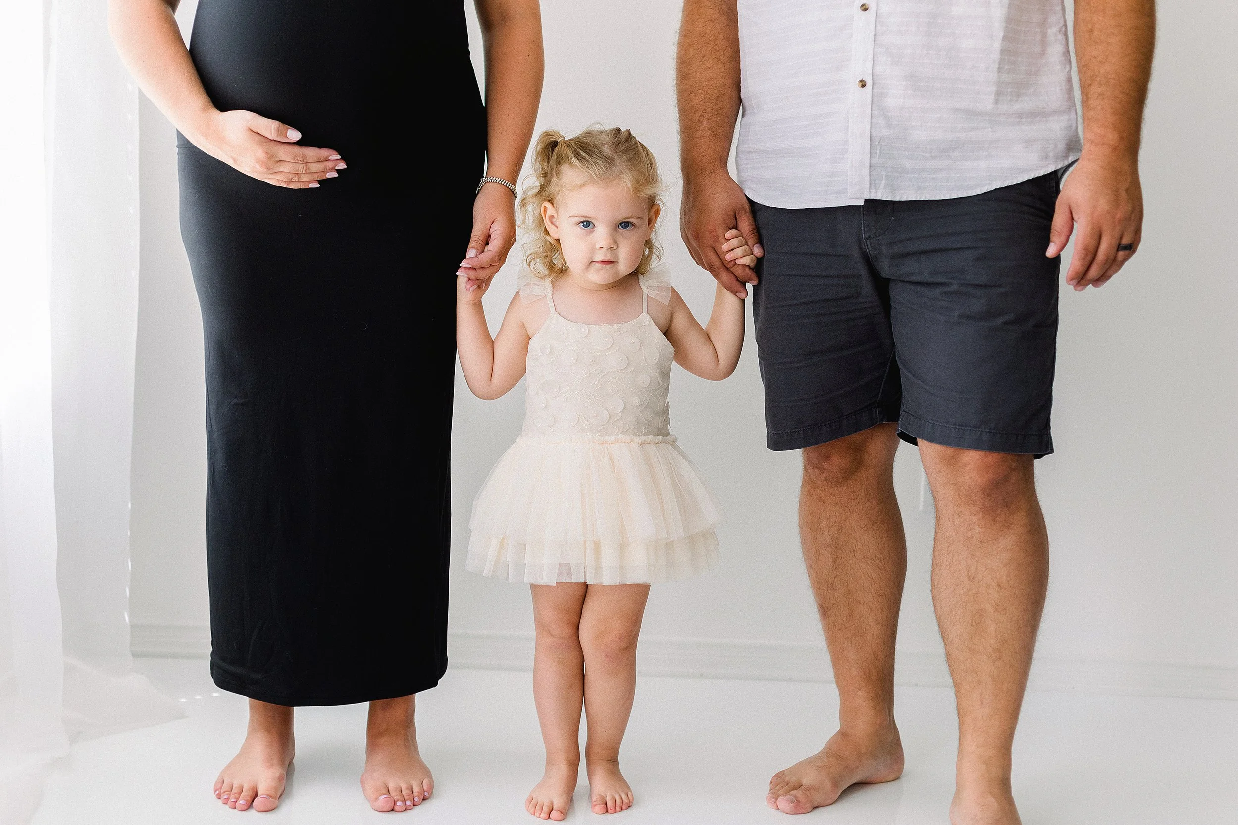 Family maternity holding toddlers hands in Bowmanville