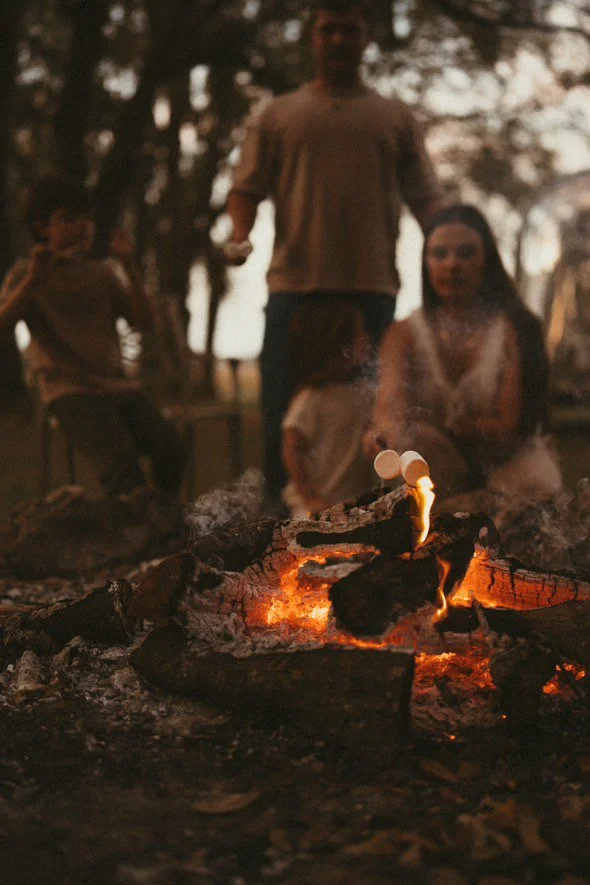 Family roasting marshmallows over fire