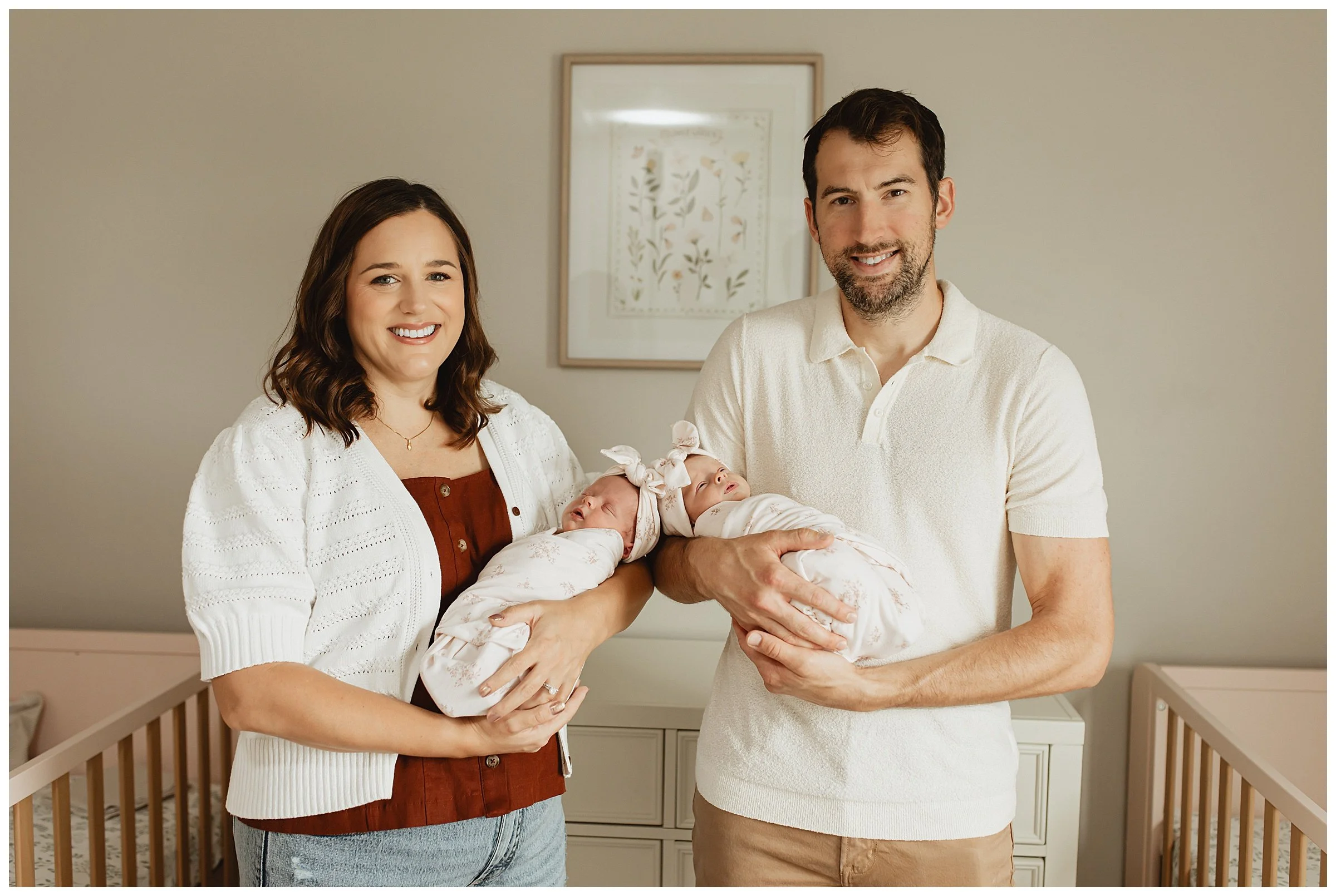   Parents holding newborn twins during a Boise lifestyle newborn photography session  