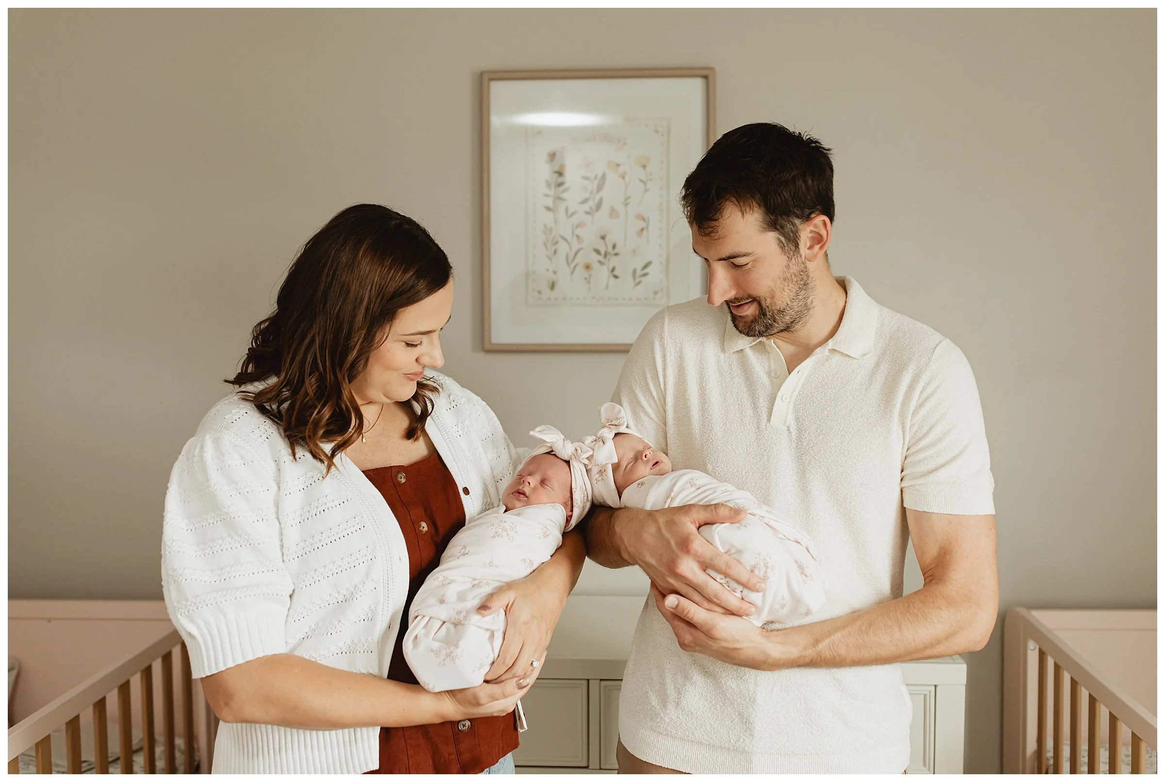   Parents holding newborn twins during a Boise lifestyle newborn photography session  