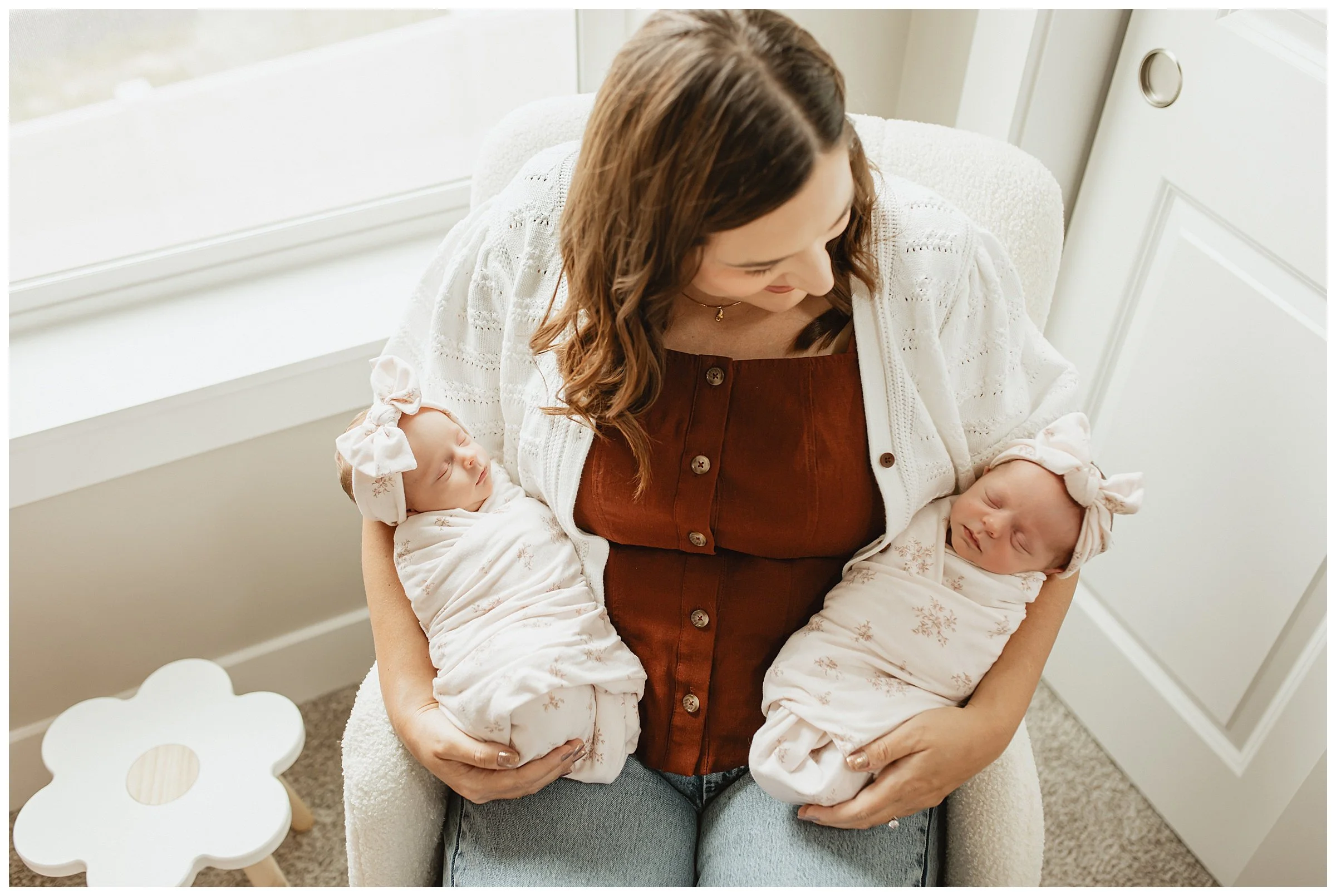   Mom holding newborn twins during a lifestyle newborn photography session in Boise  