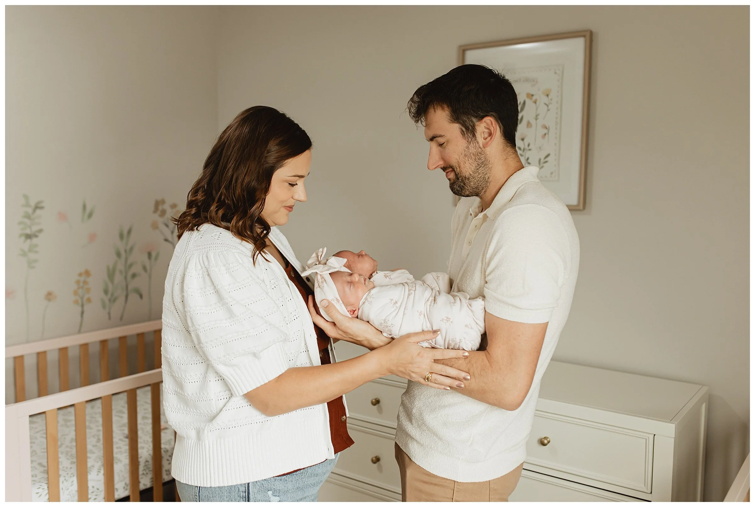   Parents cuddling newborn twins in their Boise nursery  