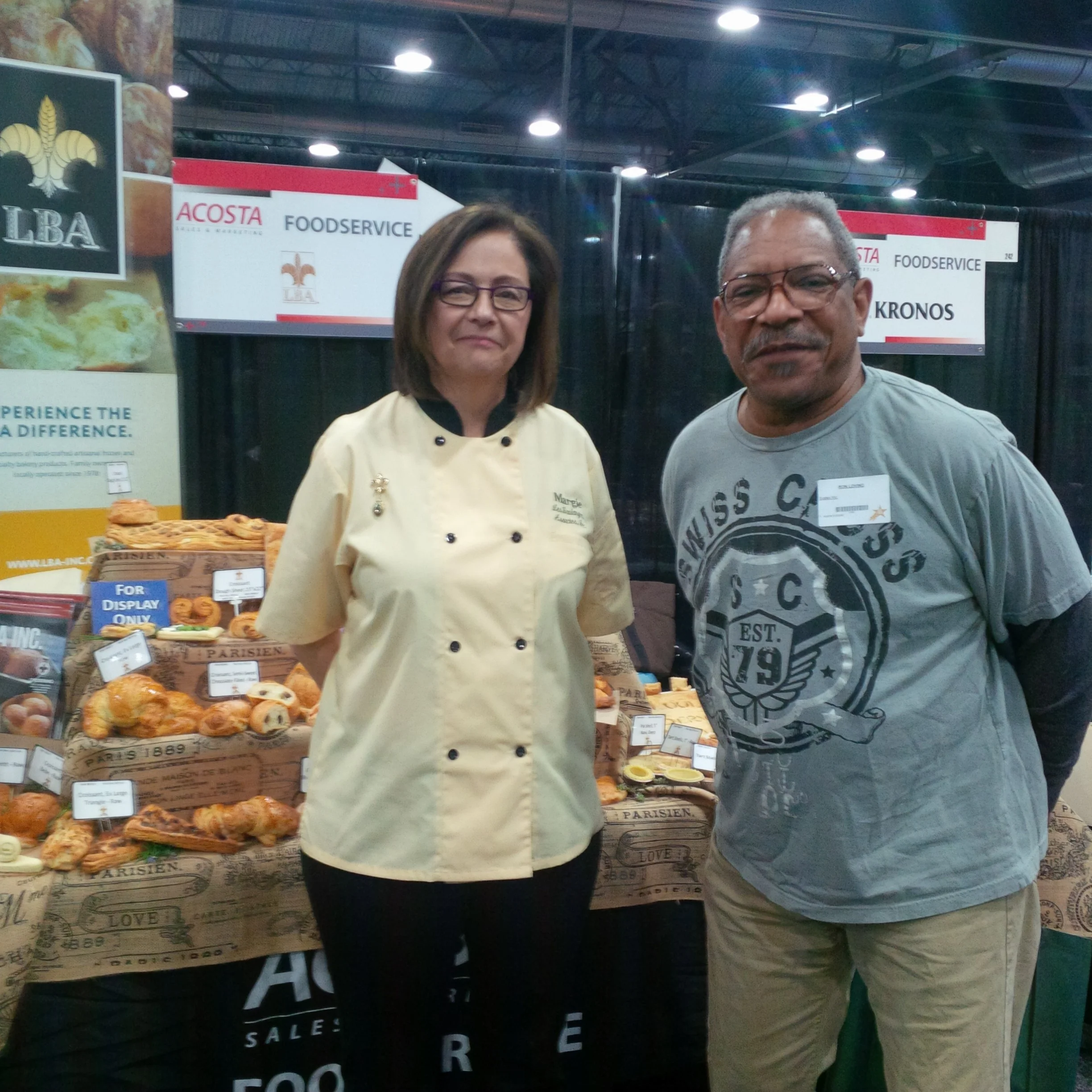 Margie Robert, owner, with Ron Livingston, B&I café manager and winner of the LBA raffle of free pastry cutting tools. Ron received free LBA baking training, spoke about accolades from customers on his fresh baked Danish and other pastries. His creativity and passion for good food, successfully transferred to LBA frozen dough.