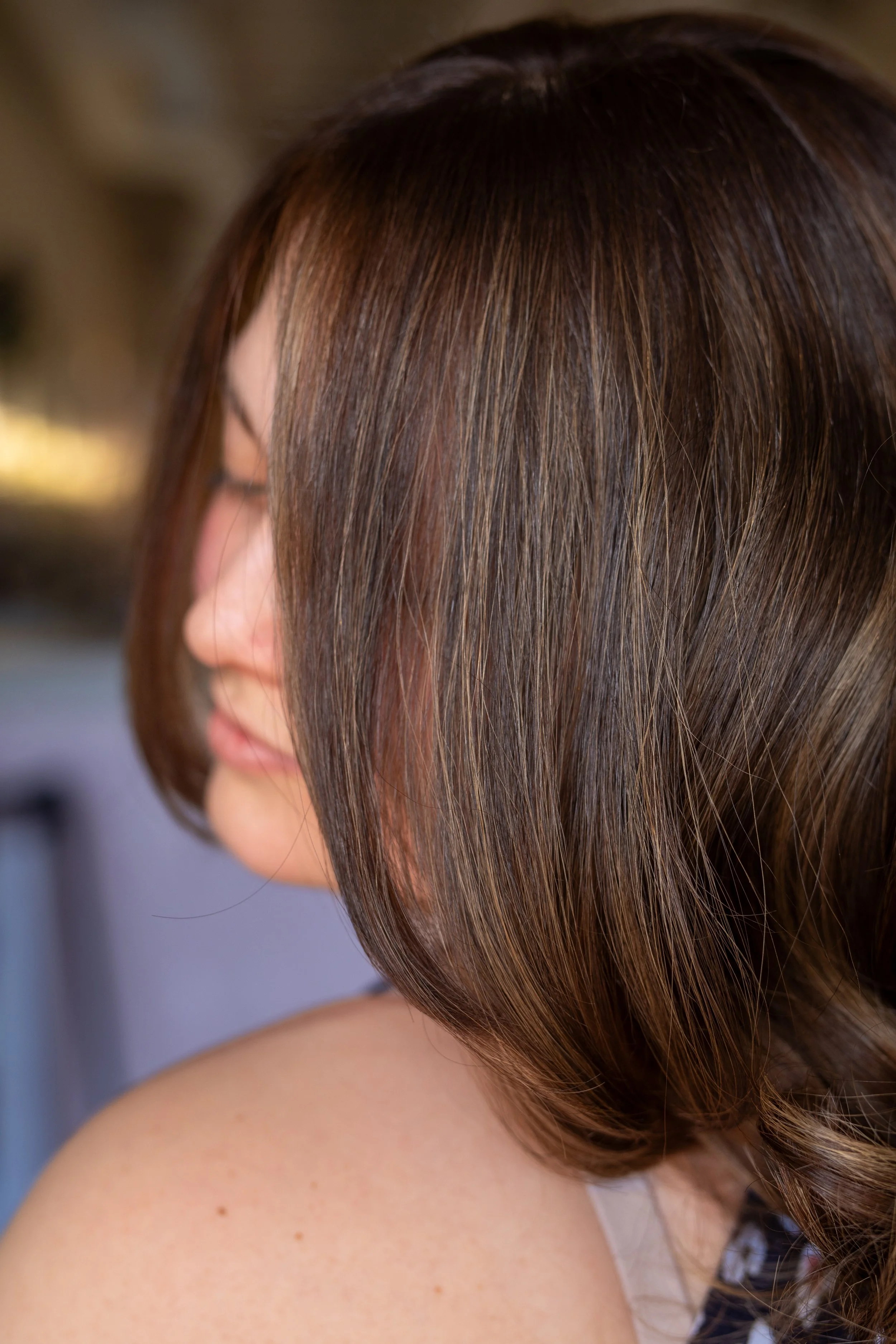 Dimensional brunette color result showing visible tonal contrast at Alchemy Park