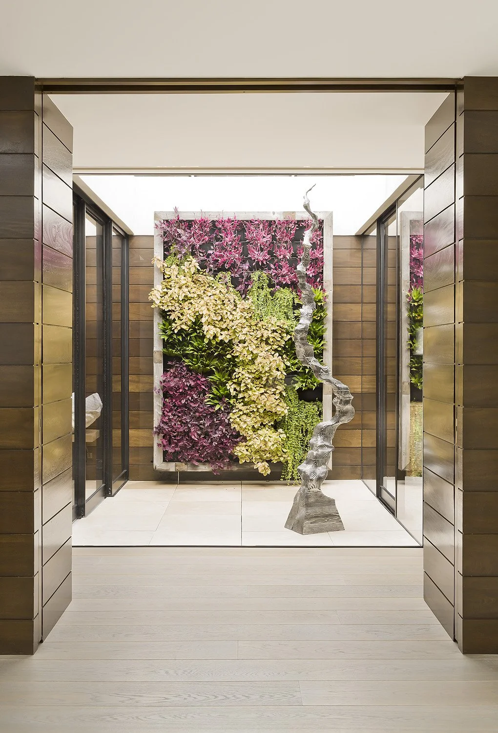 Greenwall display with modern metal sculpture designed by SUBU Design