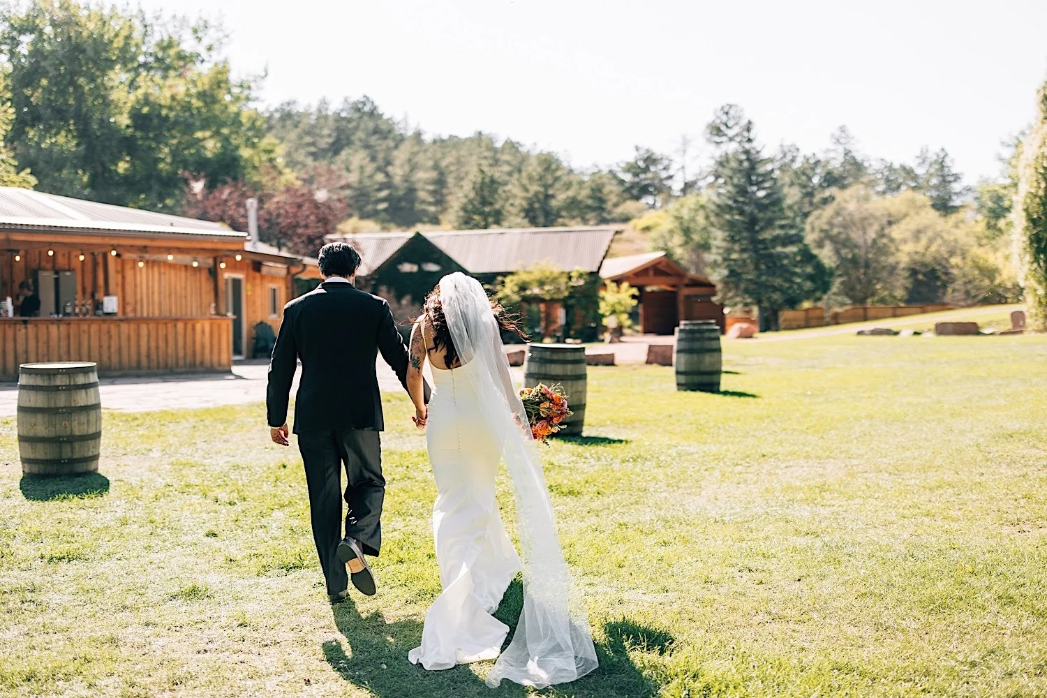 055_bride-and-groom-walk-towards-planet-bluegrass-for-cocktail-hour.jpg