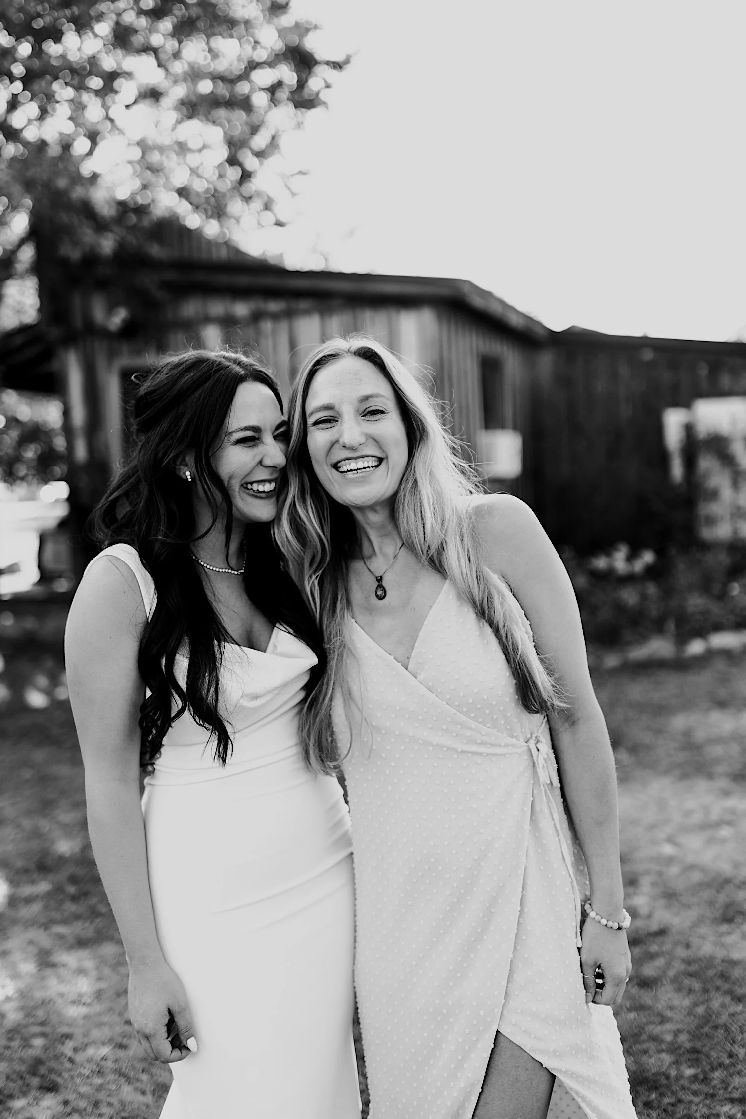 062_bride-poses-with-bridesmaid-during-cocktail-hour-at-planet-bluegrass.jpg