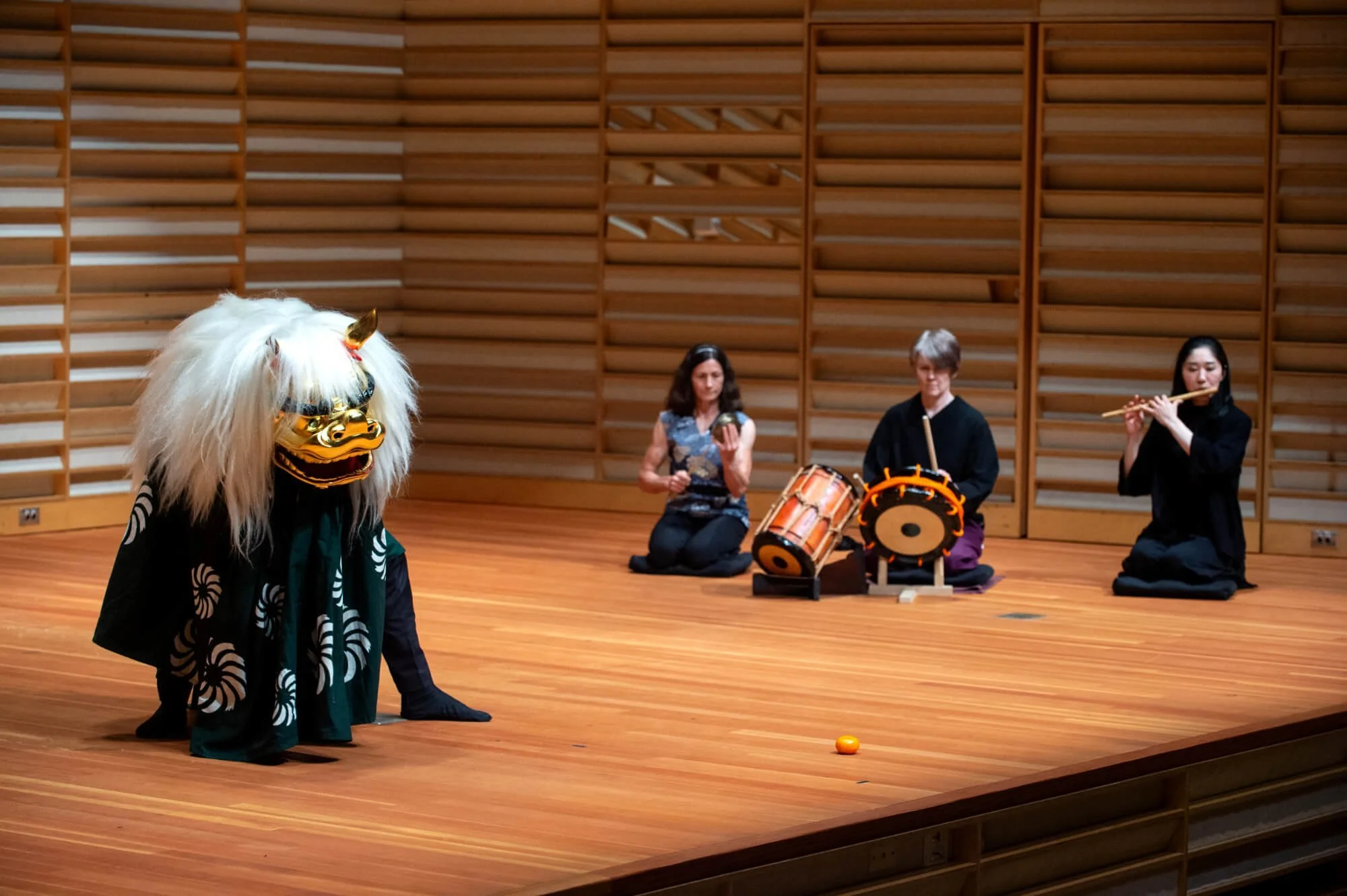 shishimai performer on stage with musicians