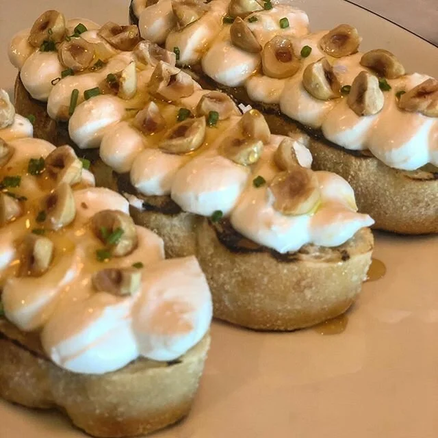 Whipped ricotta crostini, toasted hazelnuts, burnt orange honey. #keepitsimple #italian #yum #foodporn #supportlocal #southcounty #southcountyri #eater  #crostini #ricotta #hazelnut #honey