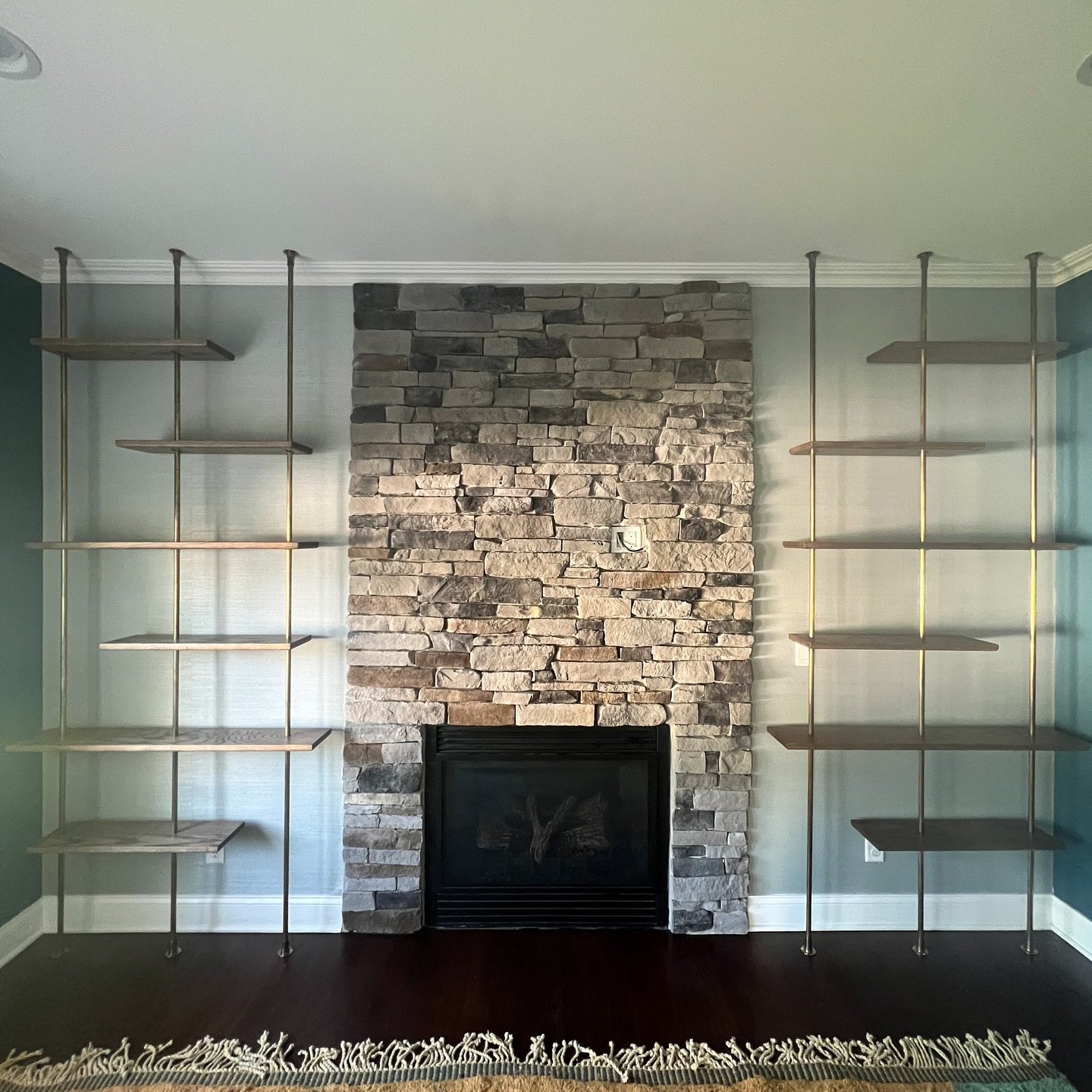 This was a cool build.  Oak shelves with floor to ceiling antiqued brass pipes.