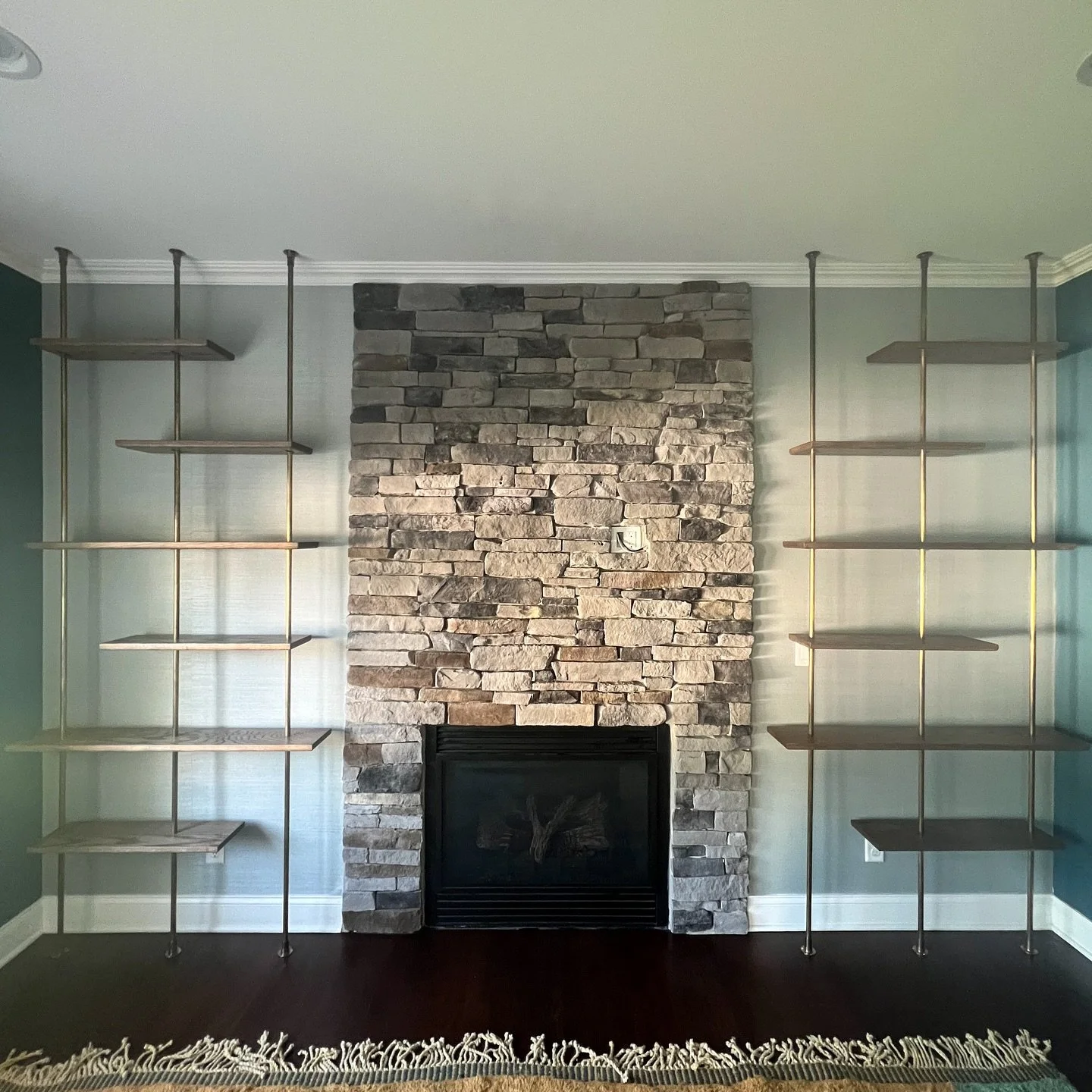 This was a cool build.  Oak shelves with floor to ceiling antiqued brass pipes.