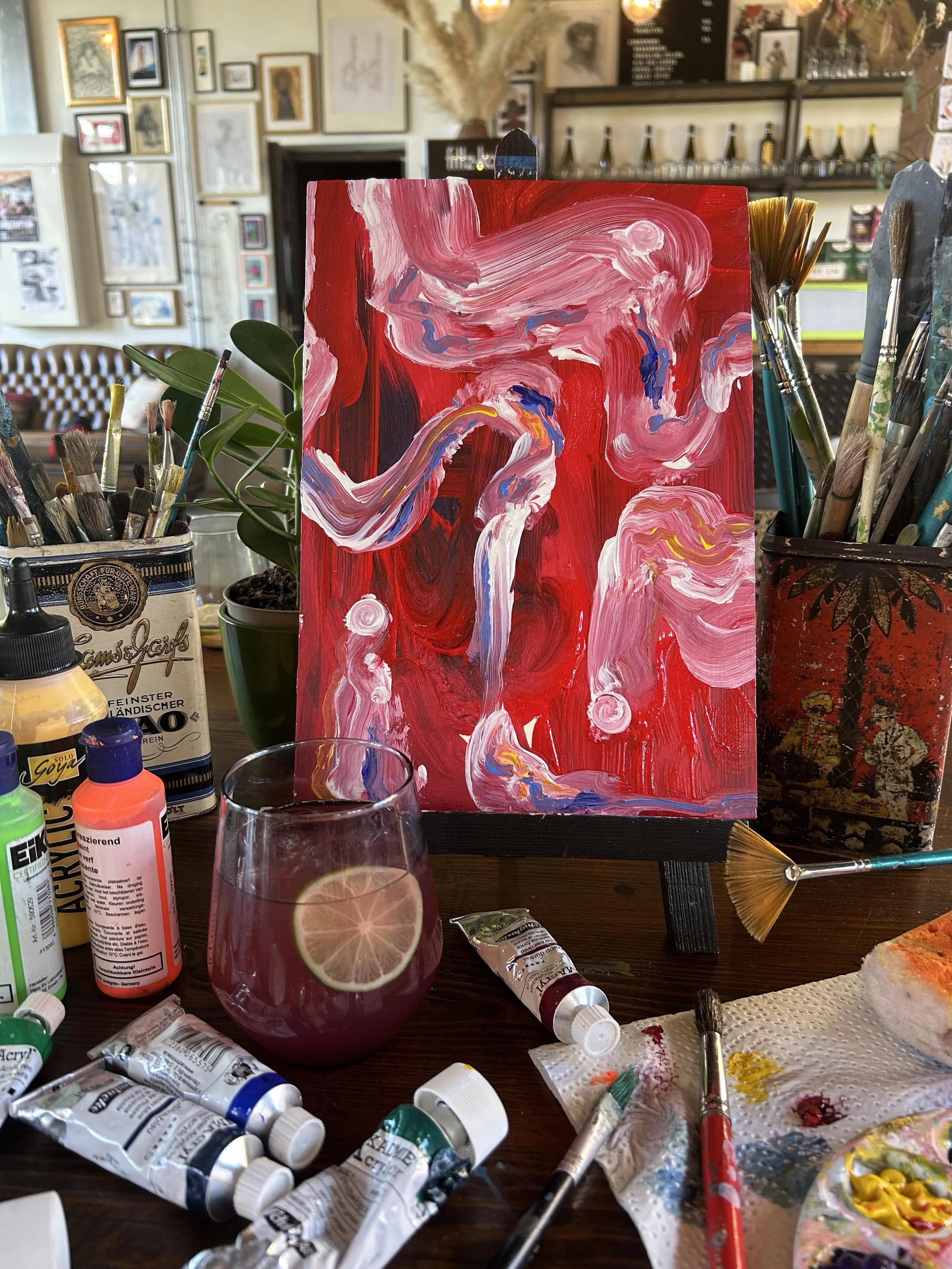 Painting Set Up In A Cozy Atelier Space With A Drink Colors And Paint Brushes