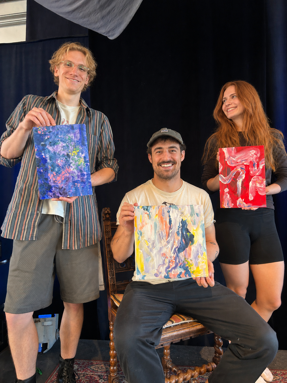 Sip and Paint- Stylish Young People smiling and holding up Abstract Oil Paintings