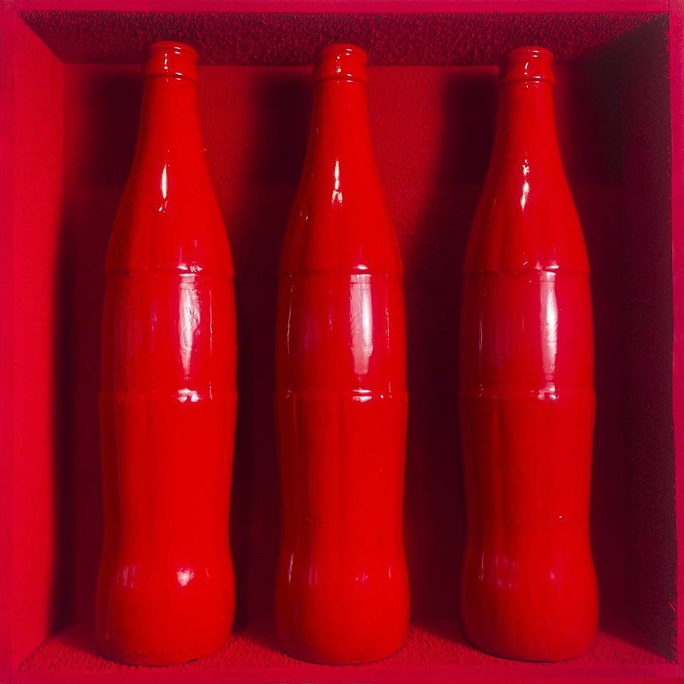  “Threesome: “Red Latex” Three painted Mexican Coke bottles in a custom-built wall display. 