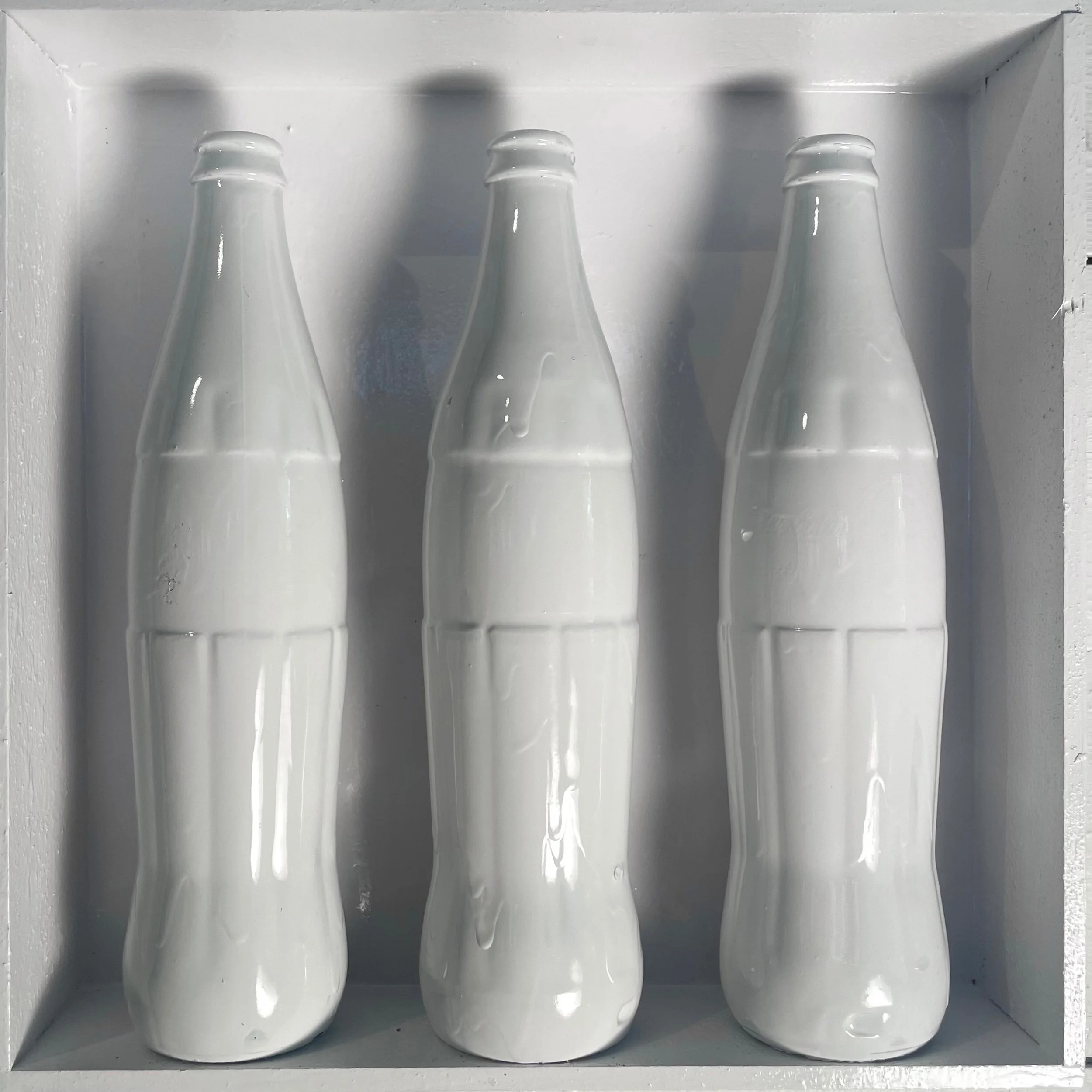  “Threesome: Milk” Three painted Mexican Coke bottles in a custom-built wall display. 