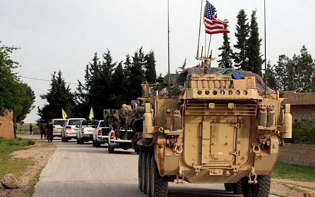 U.S. forces accompanied by members of the Kurdish People’s Protection Units. (Delil Souleiman/AFP.)