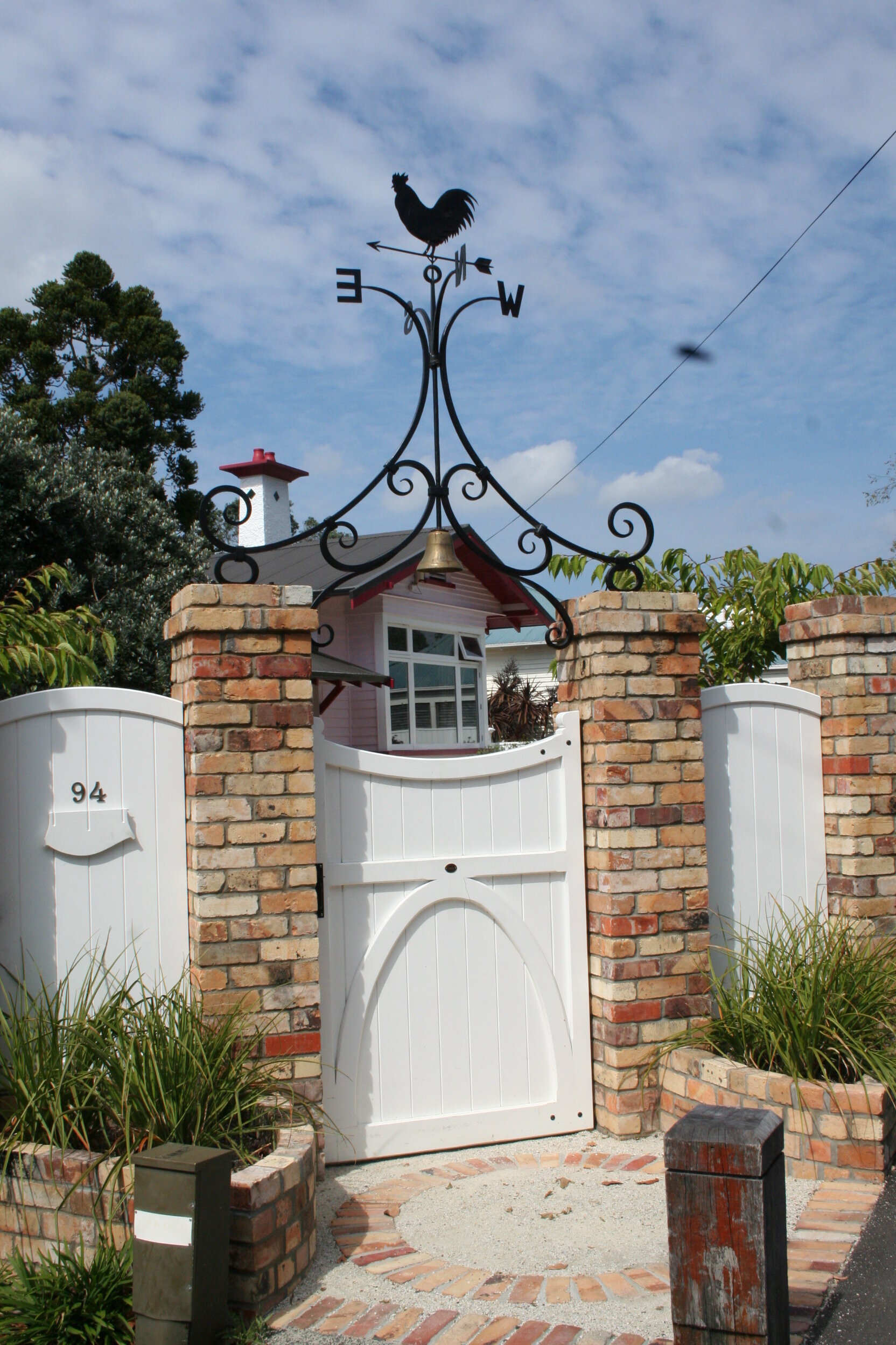 Gate overthrow with weather vane