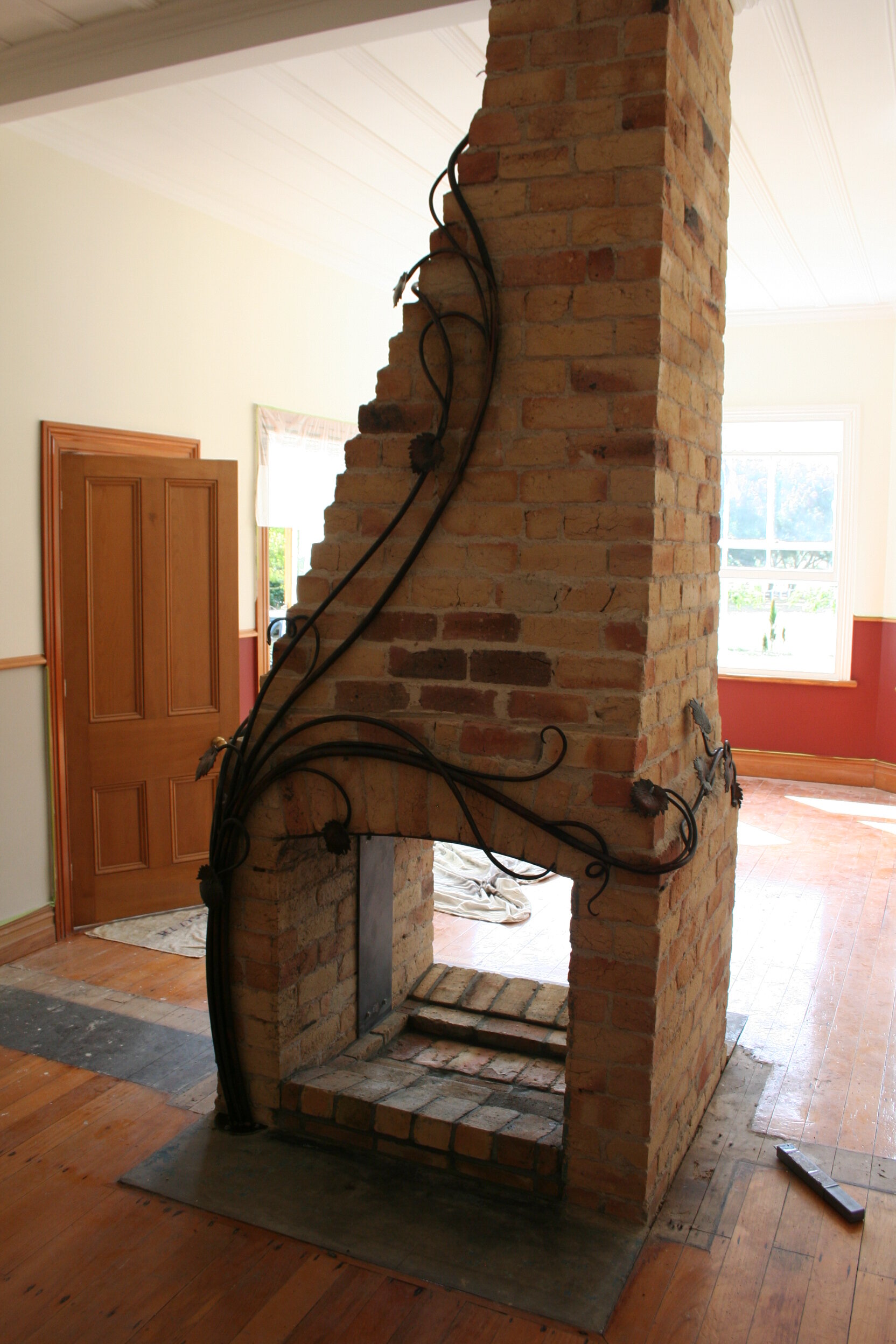 Sculptural Vine added to a fire place.