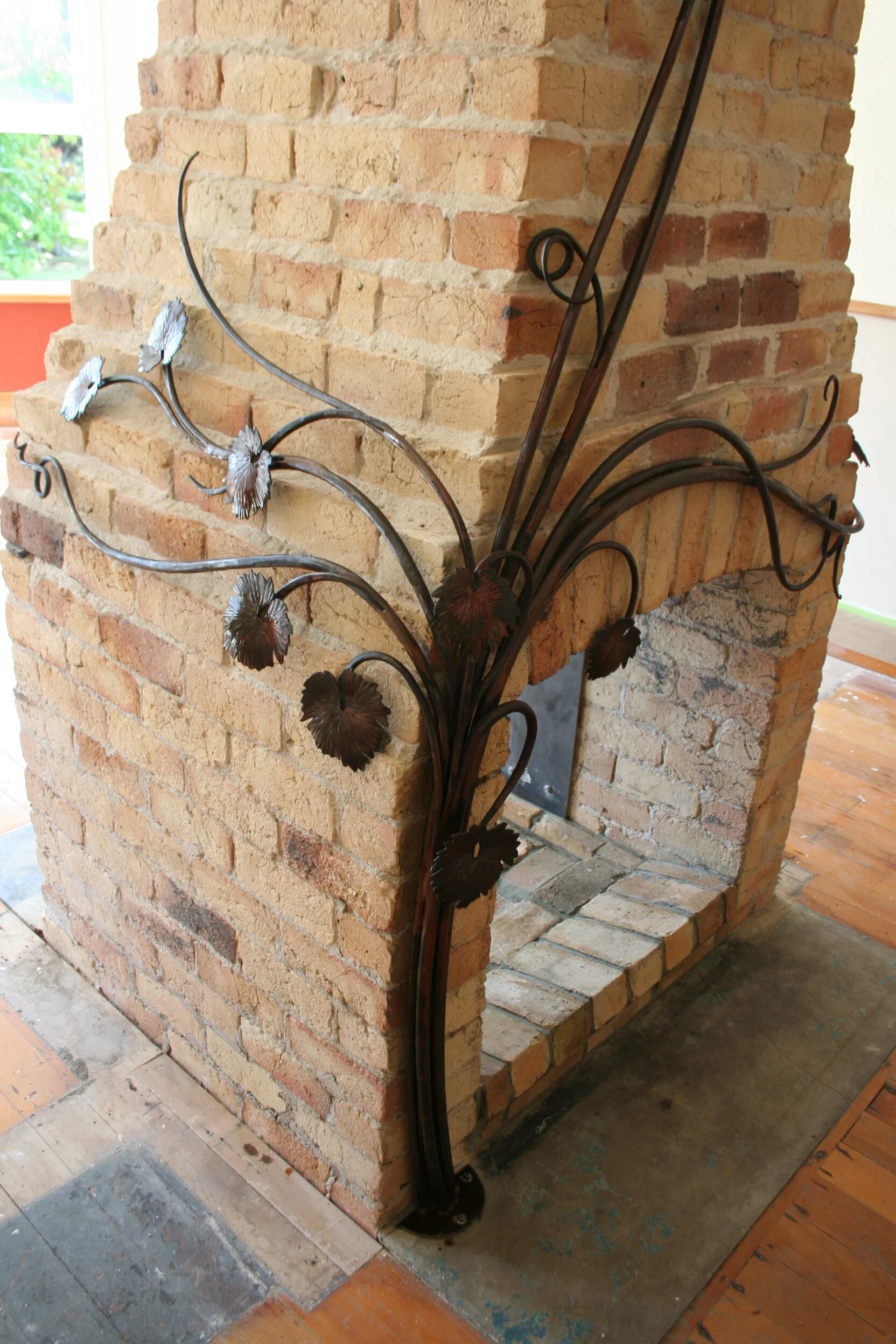 Sculptural vine added to a fireplace.