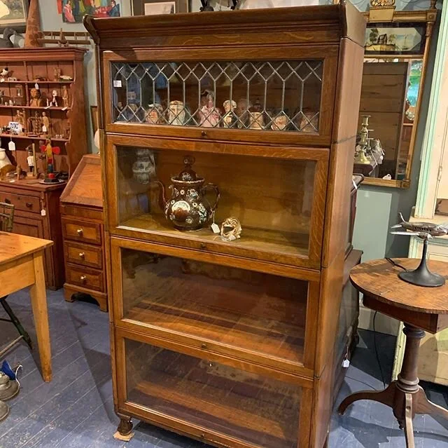 $1295. *Original finish four section stacking bookcase with a leaded glass section and ball and claw feet all in quarter sawn oak. Circa 1920-30. 34”wide x 66” tall x 12” deep. The overall design of this bookcase suggest it may be f
