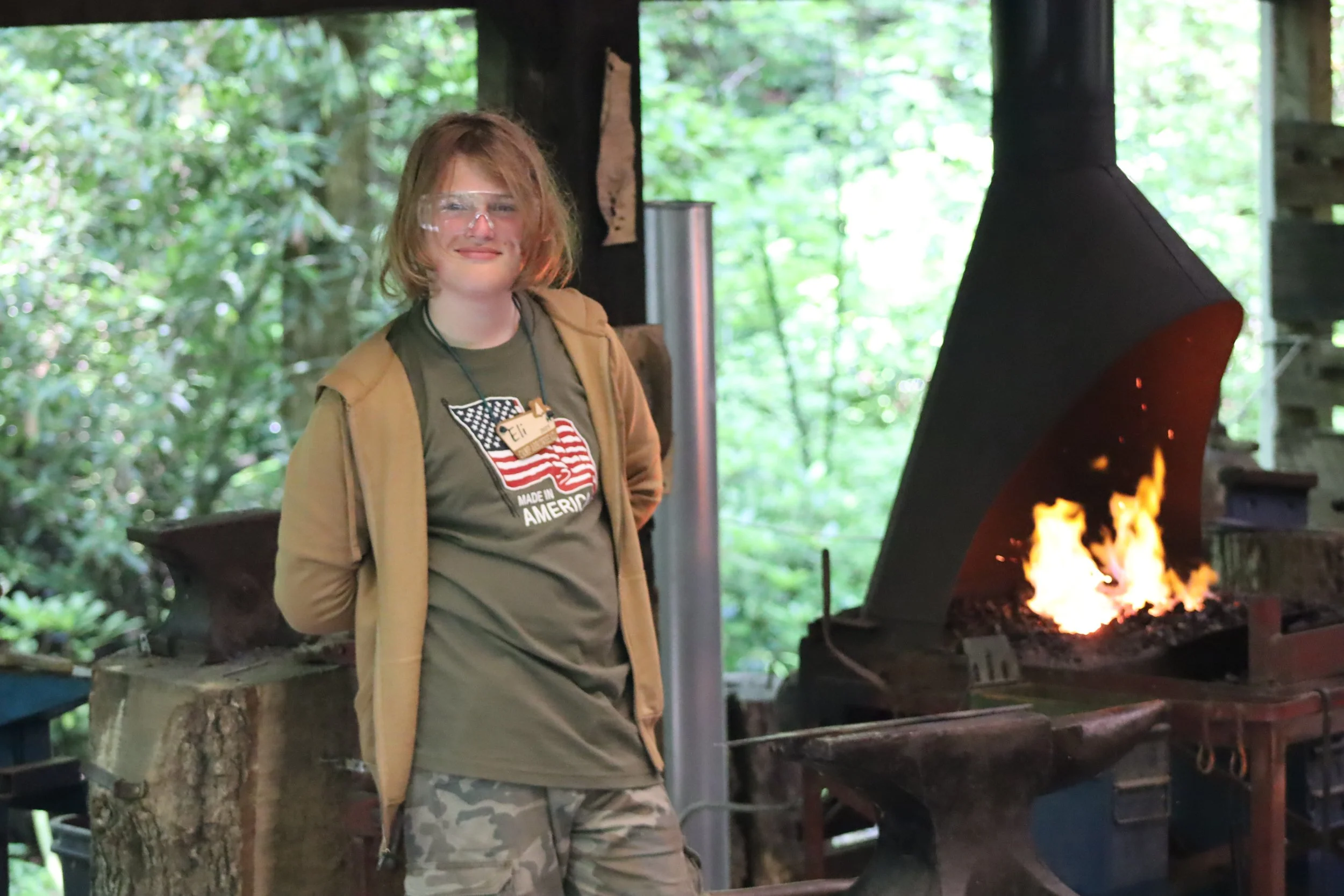 Camper Eagerly awaits his chance to hammer in Blacksmithing. 