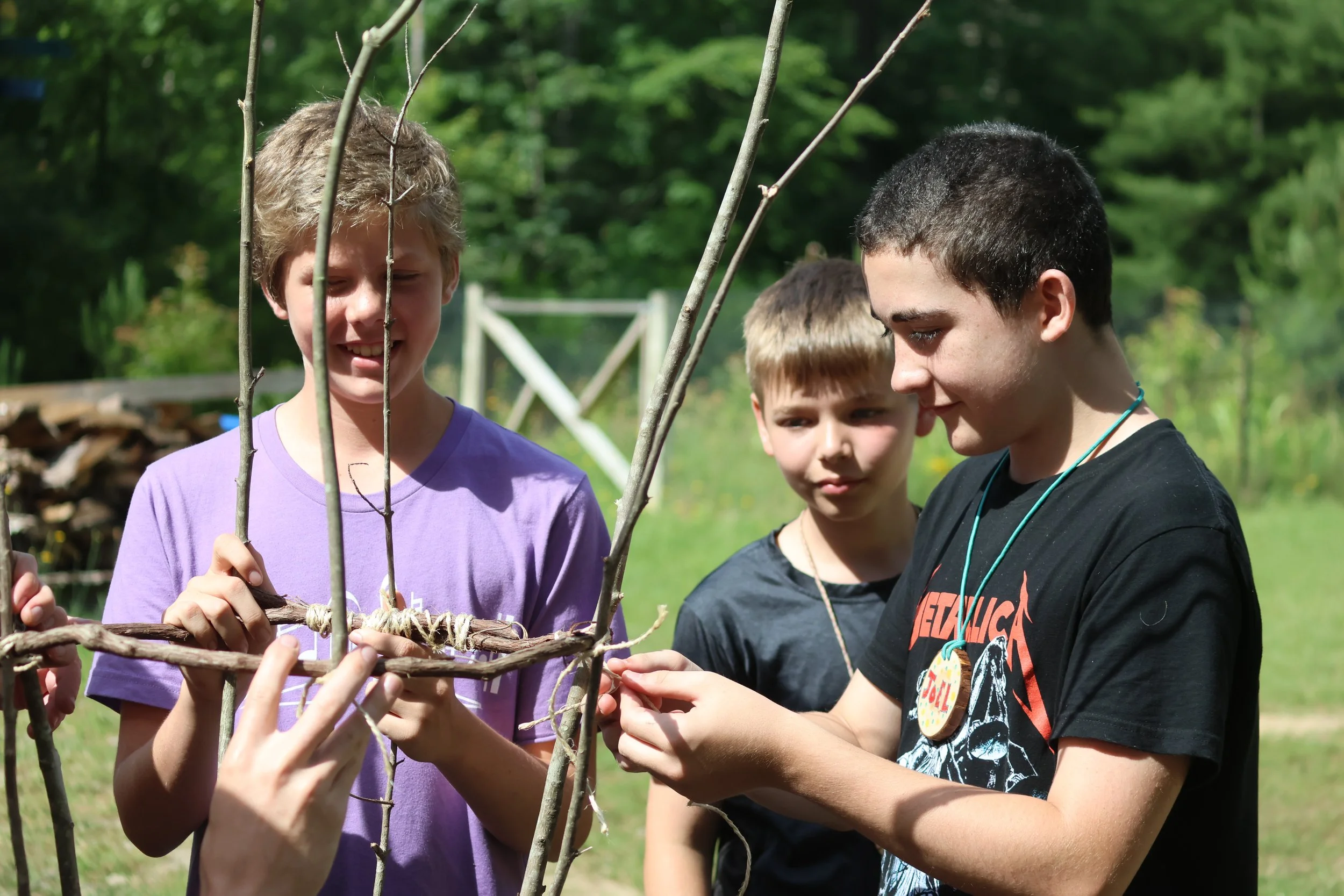Campers working together on a bushcraft project at Camp Arrowhead in North Carolina. 