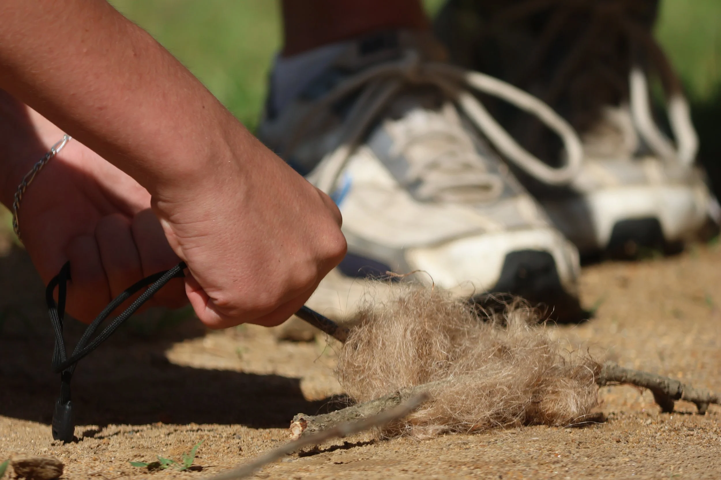 Camper practicing flint and steel fire lighting in Bushcraft for Survival knowledge. 
