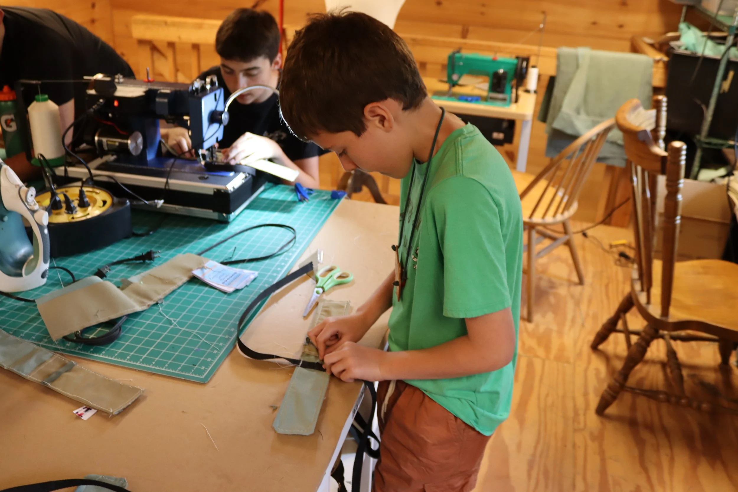 Camper assembling his final sewing project at Camp Arrowhead. 