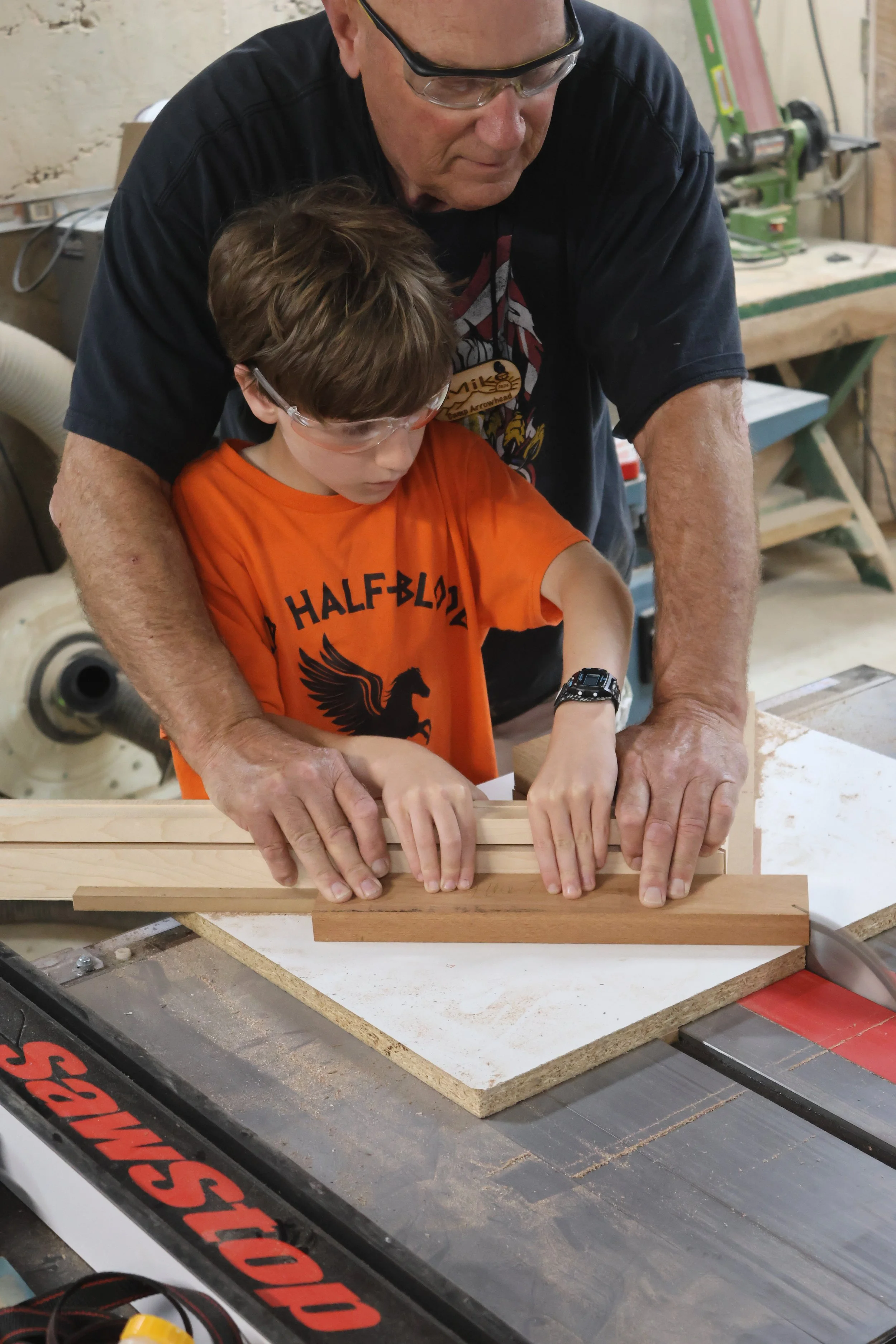 Young Maker learning how to safely operate the table saw at Camp Arrowhead. 