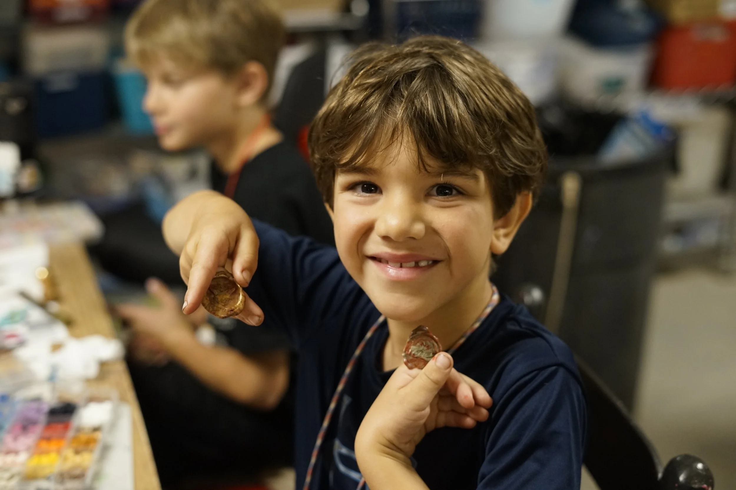 Happy young camper in the Art room at Camp. 