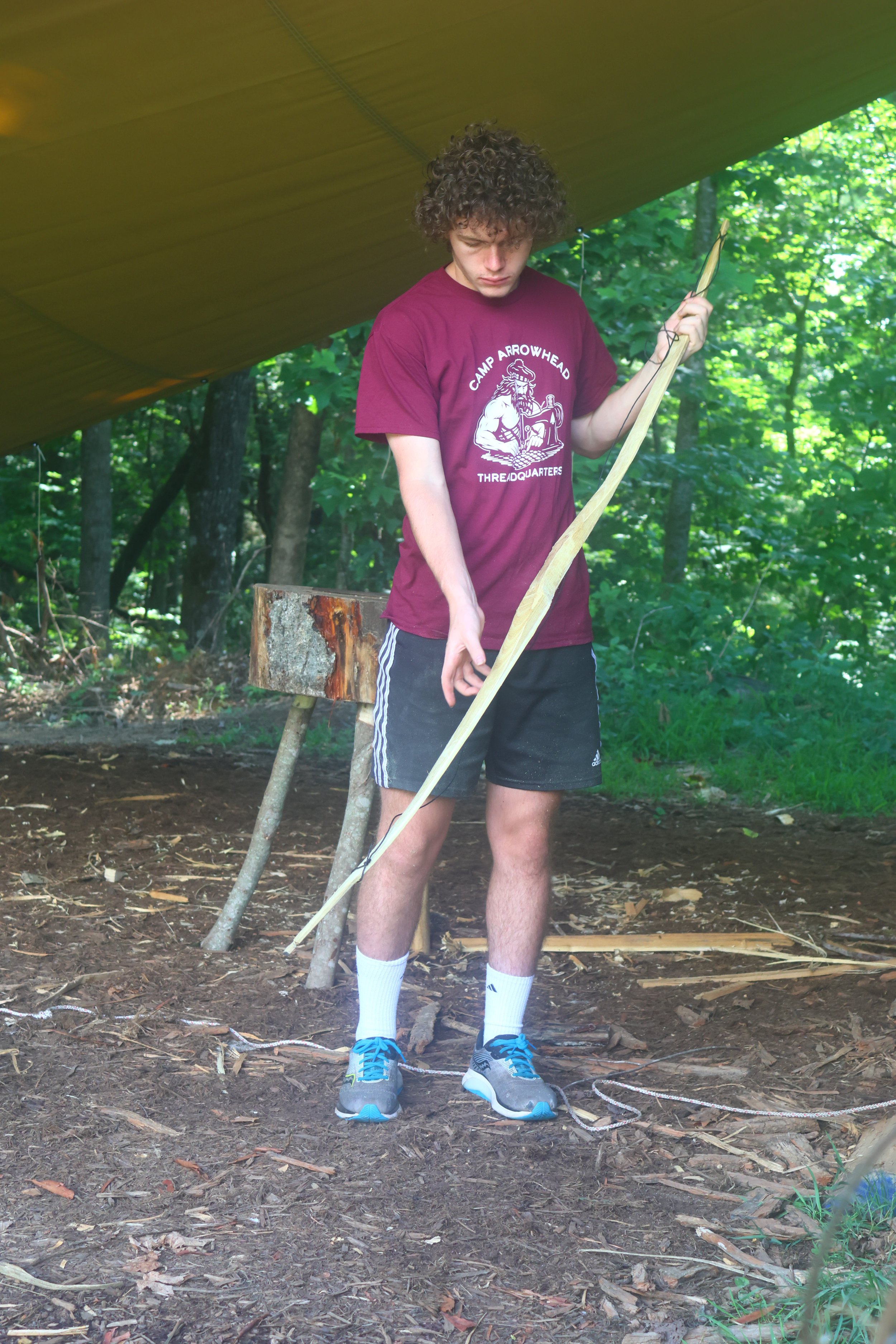  Camper testing his self bow in bushcraft at Camp Arrowhead for Boys in NC.    