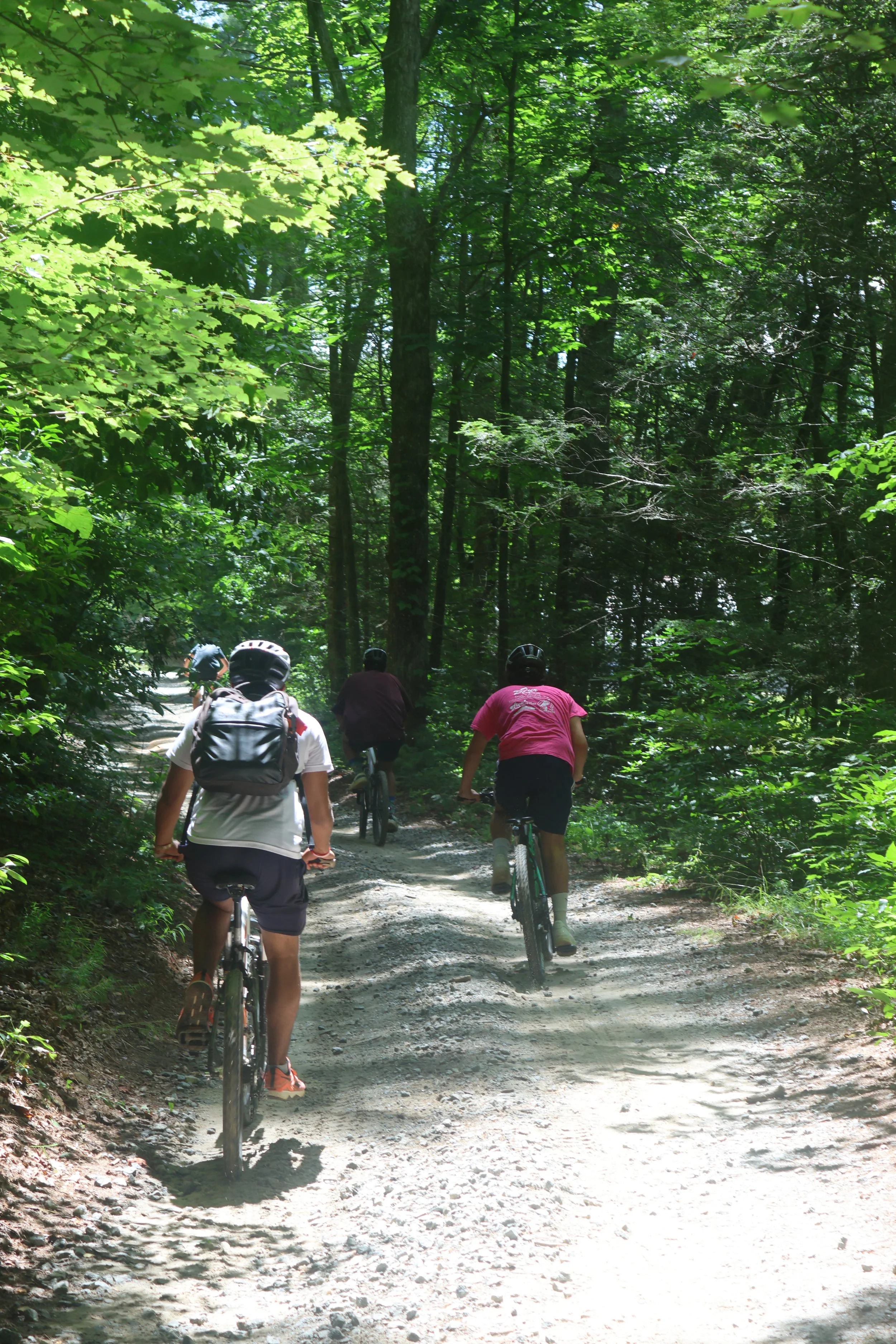 Sleepaway campers ride into camp arrowhead on mountain bikes in North Carolina. 