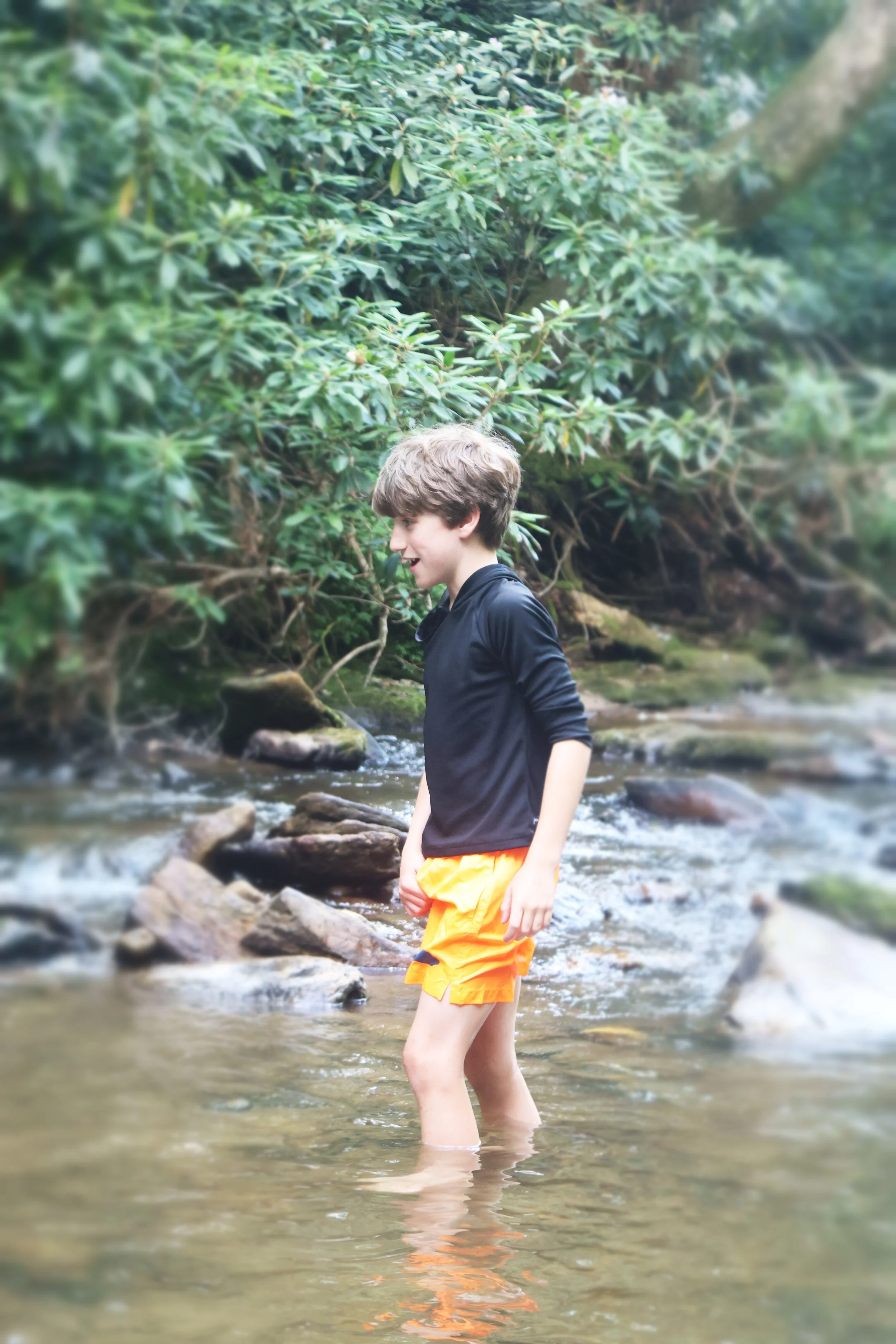  Overnight Camper enjoys stomping through the stream at Camp Arrowhead in NC.  