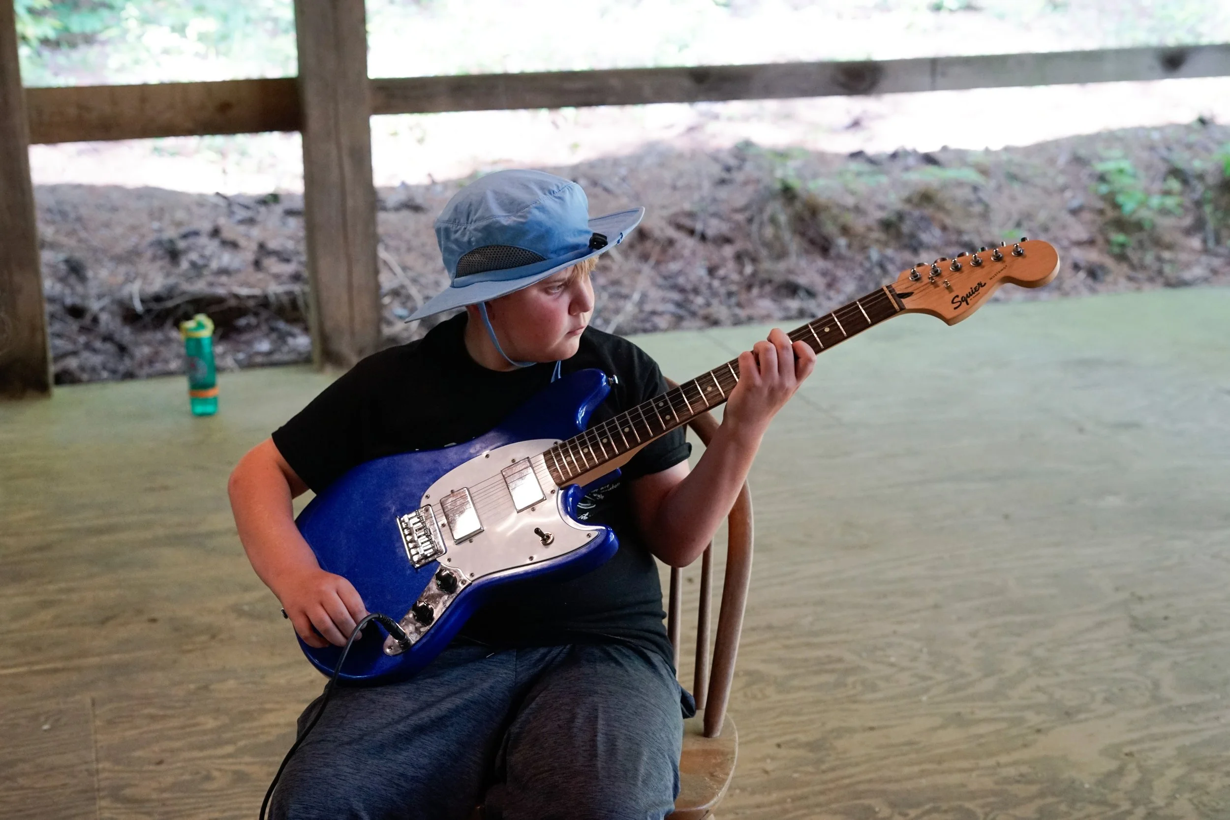 Overnight camper learns to play the electric guitar in music at Camp Arrowhead in North Carolina. 