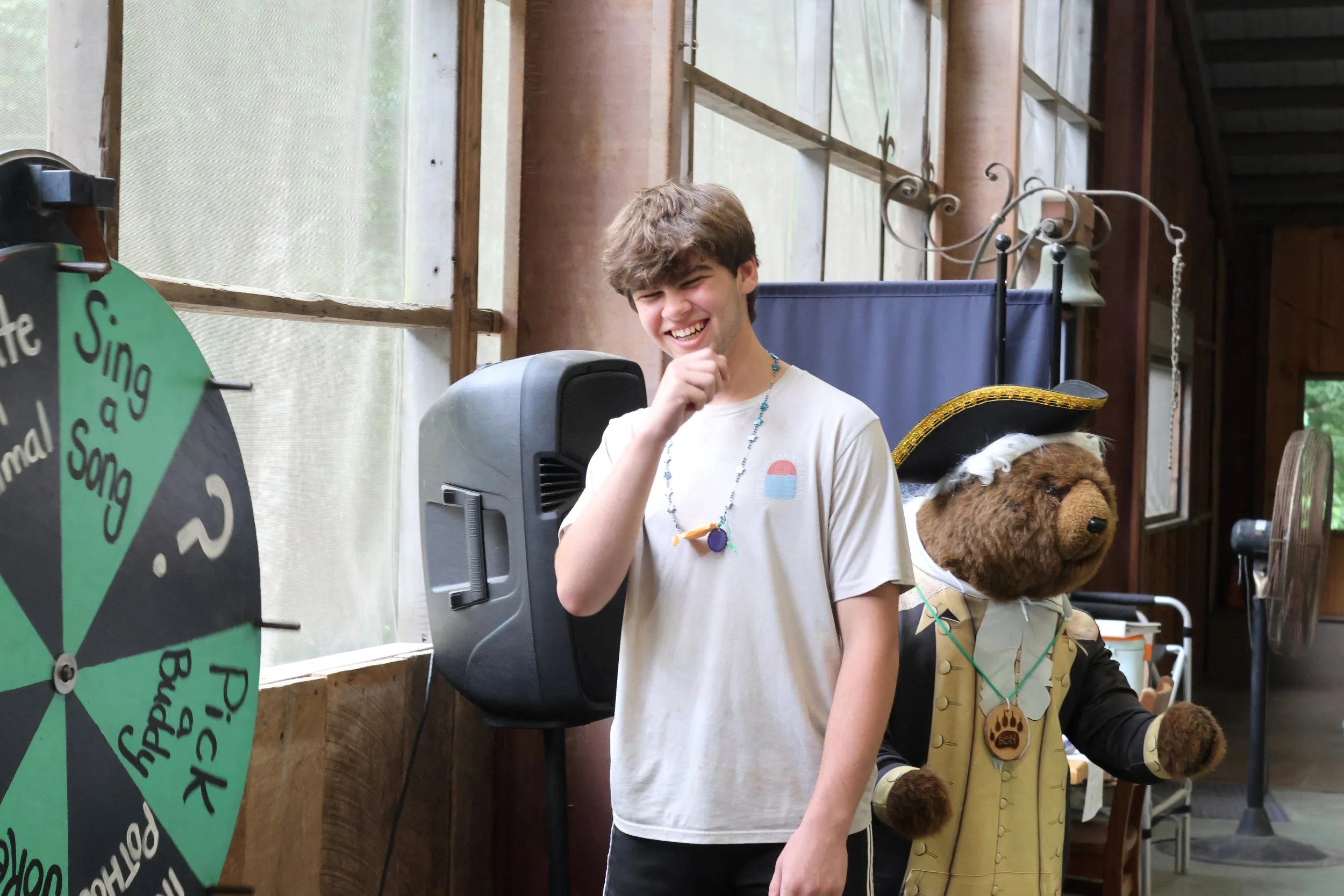 Arrowhead Camper smiles while spinning the wheel at camp in North Carolina.