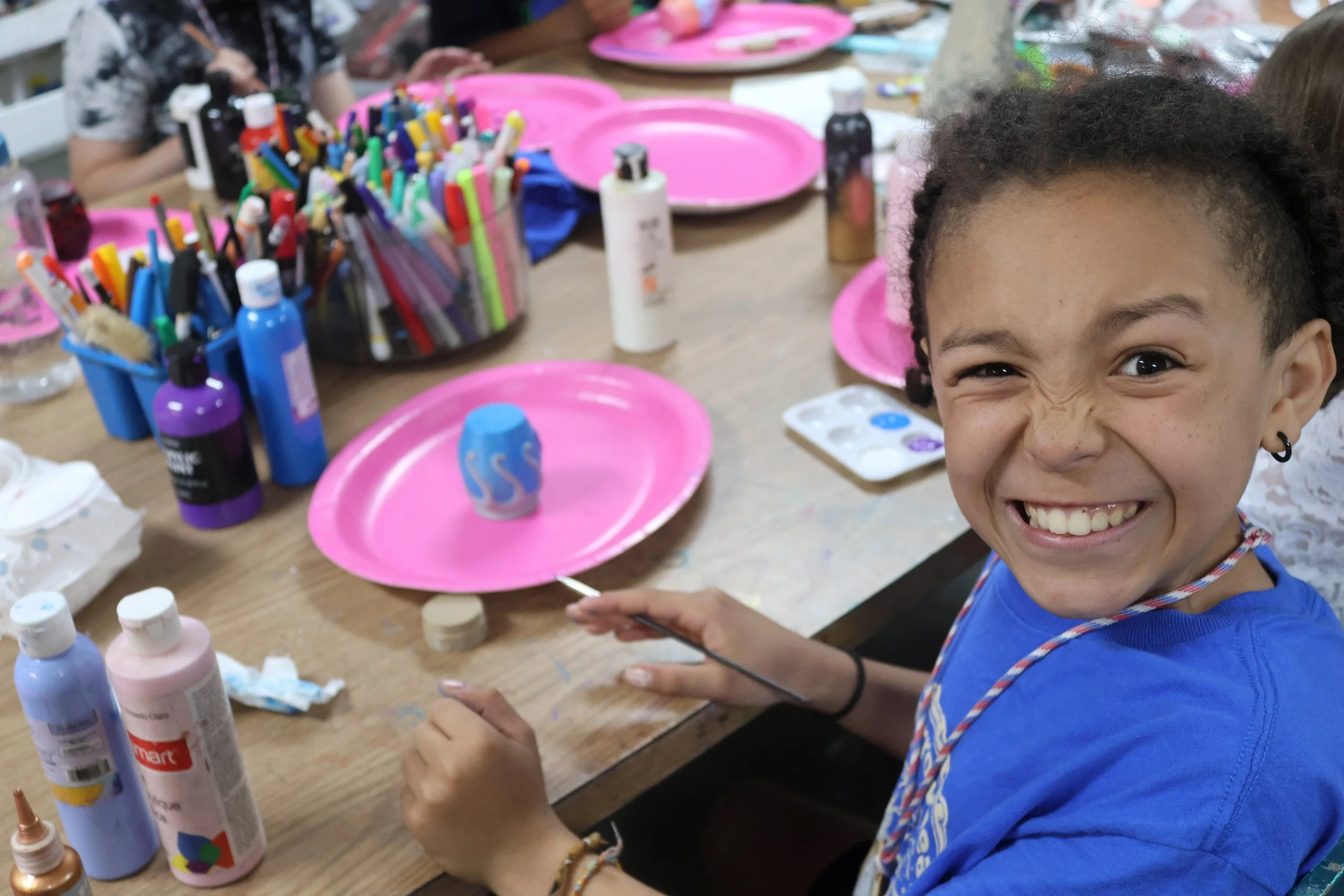 Camp Arrowhead camper having fun and being silly in art