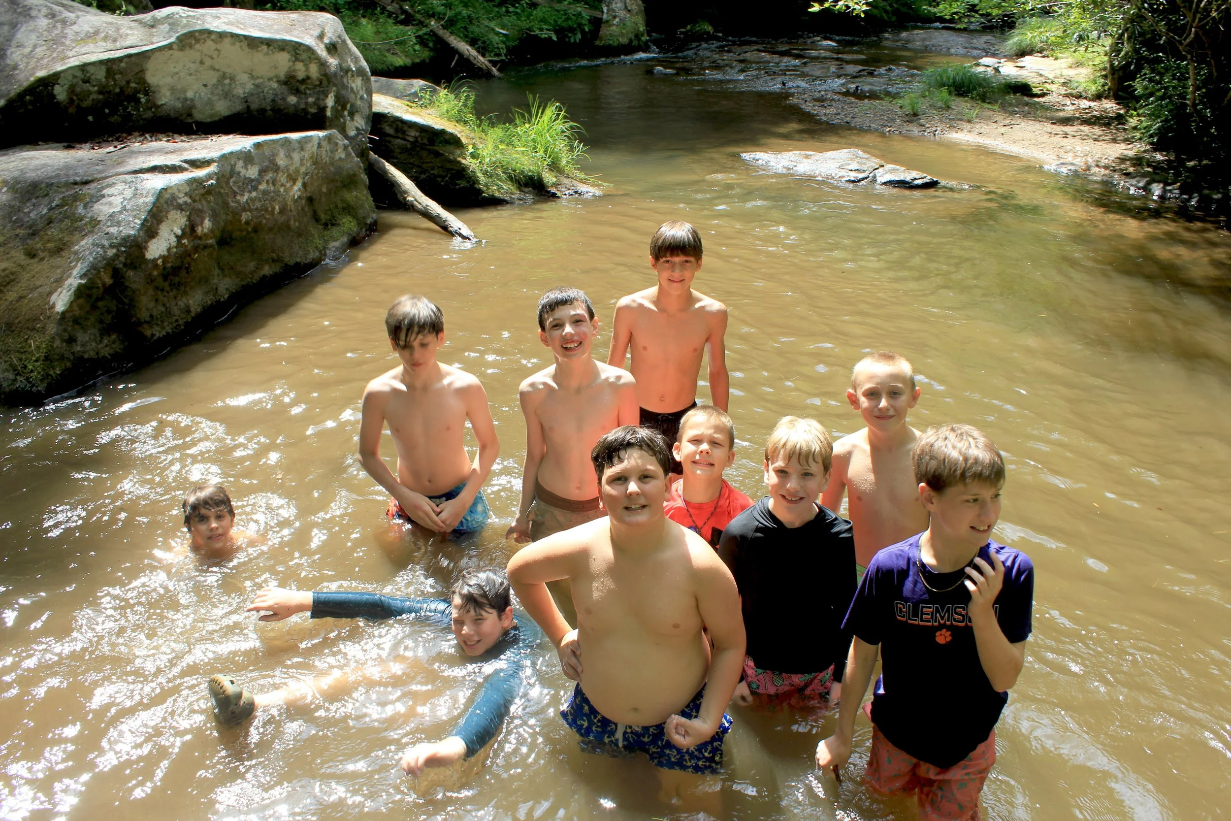 Camp Arrowhead boys playing in the river on an adventure