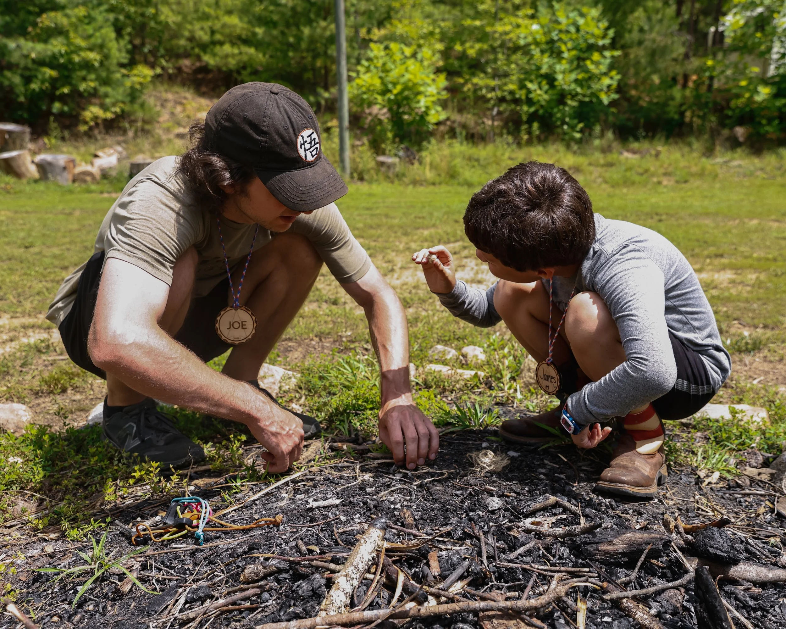 Camp Arrowhead staff member helping a camper