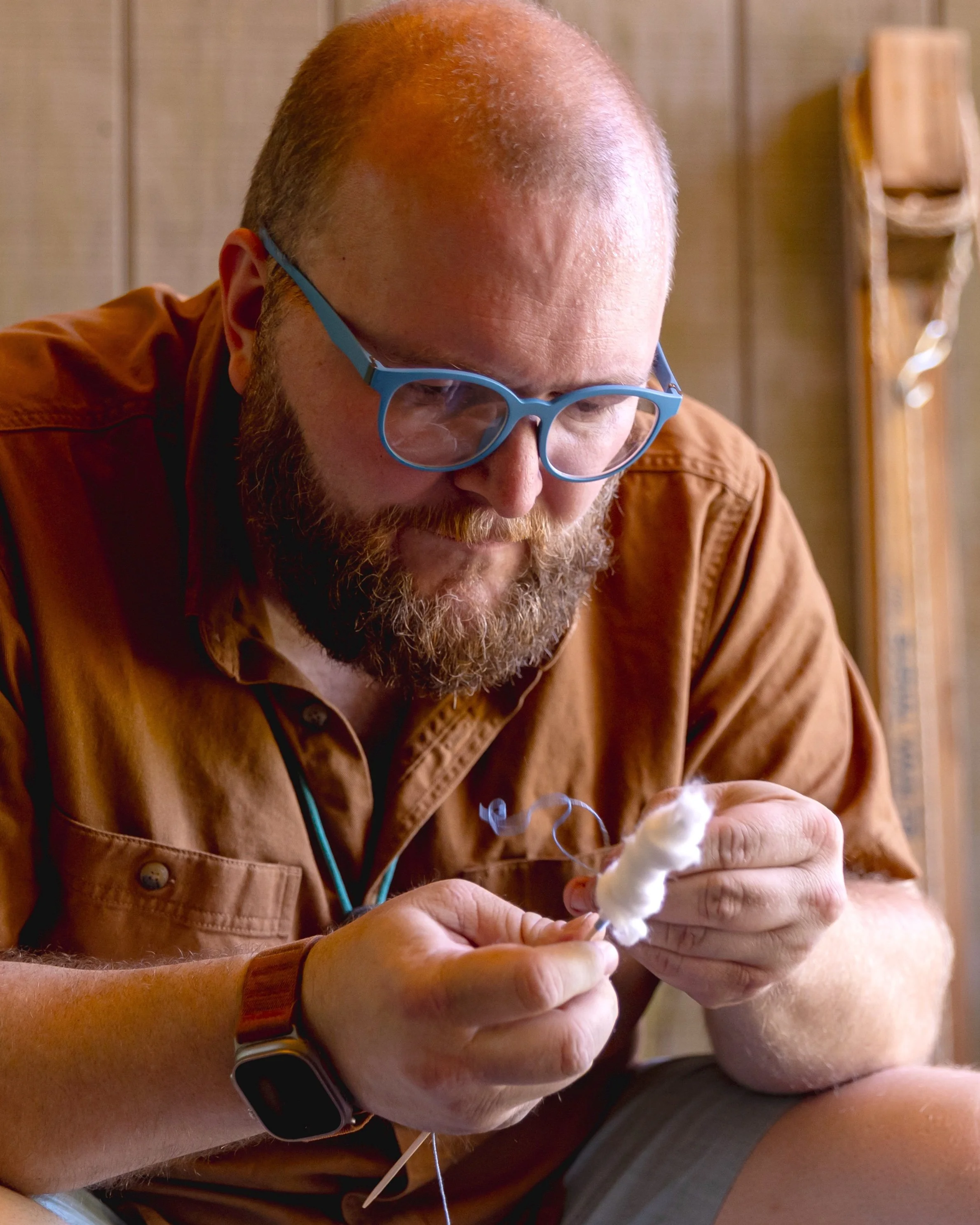 Director Justin Ausburn working on a bushcraft project at Camp Arrowhead.