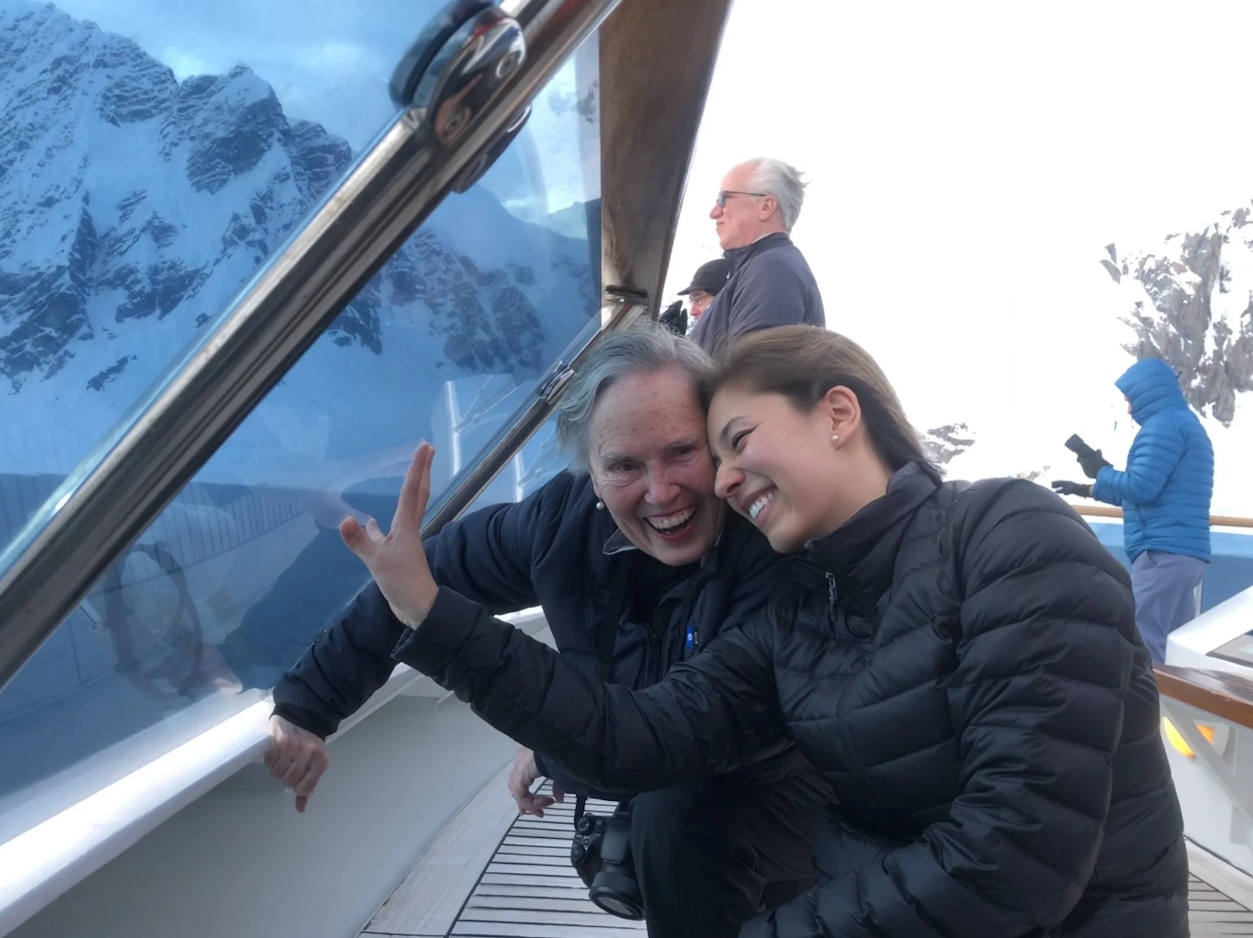 Joan &amp; I on New Years Eve, after dinner, ducking down to find relief from the crazy wind as the National Geographic Orion broke through fast ice to dock us for the evening.