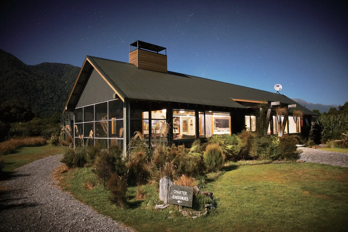 Martins Bay lodge at night (image courtesy of Ngai Tahu Tourism).