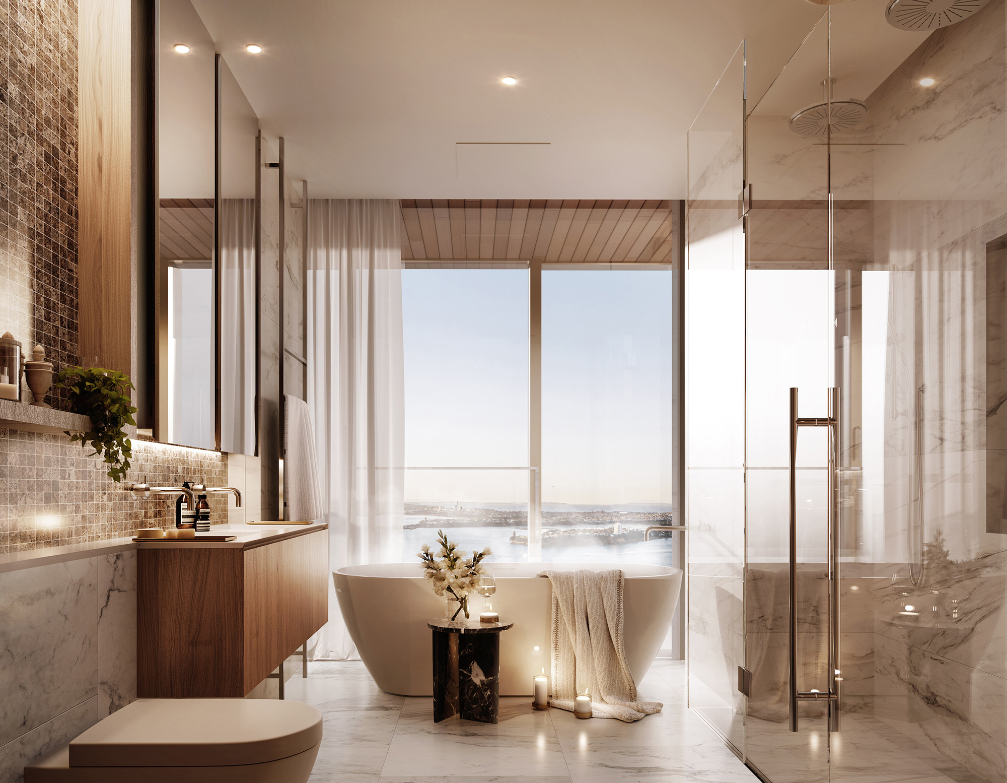  The ensuite features a double vanity, double shower and freestanding bath with views to the harbour beyond. 