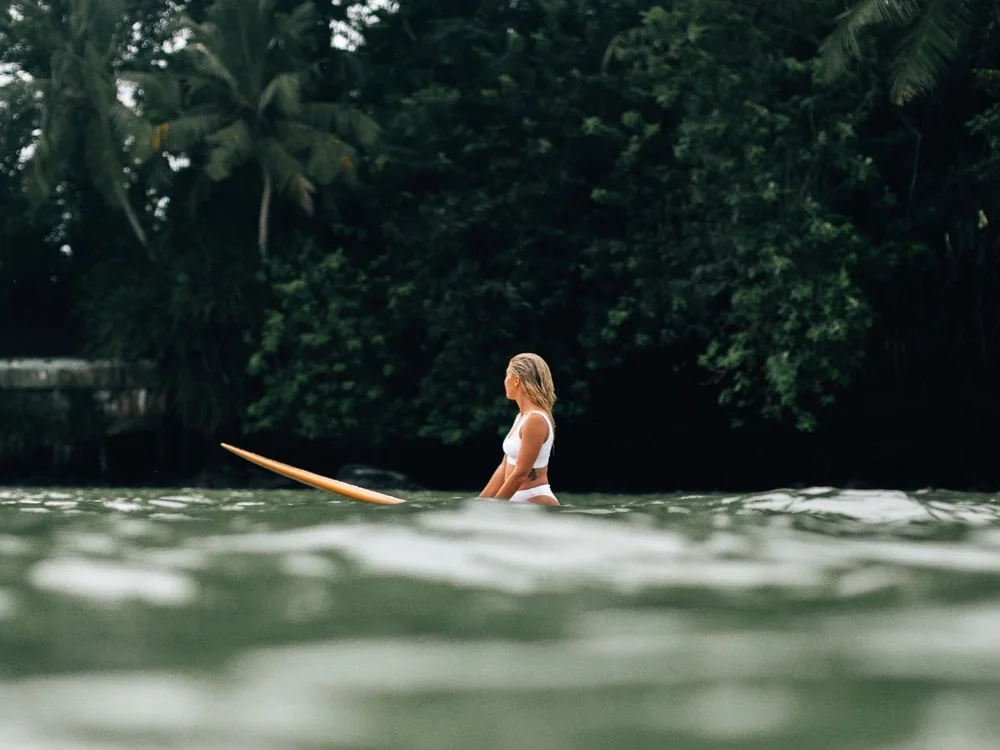 Guest surfing at sunset during the Basic package at Layback