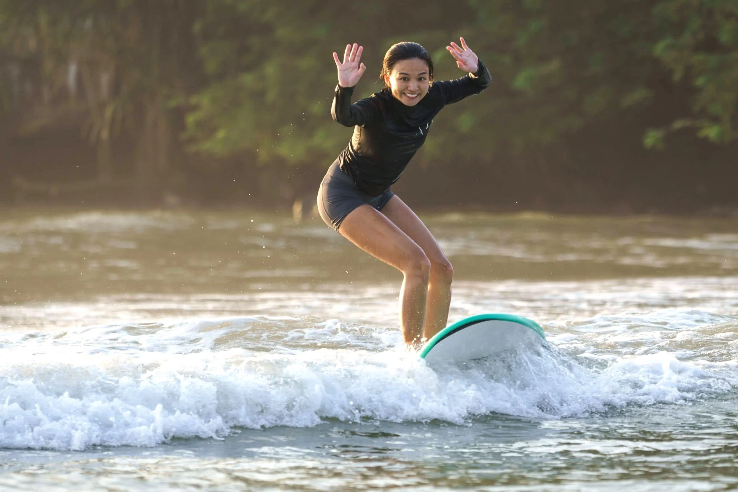 Beginner surfer riding a clean wave in Weligama, Sri Lanka