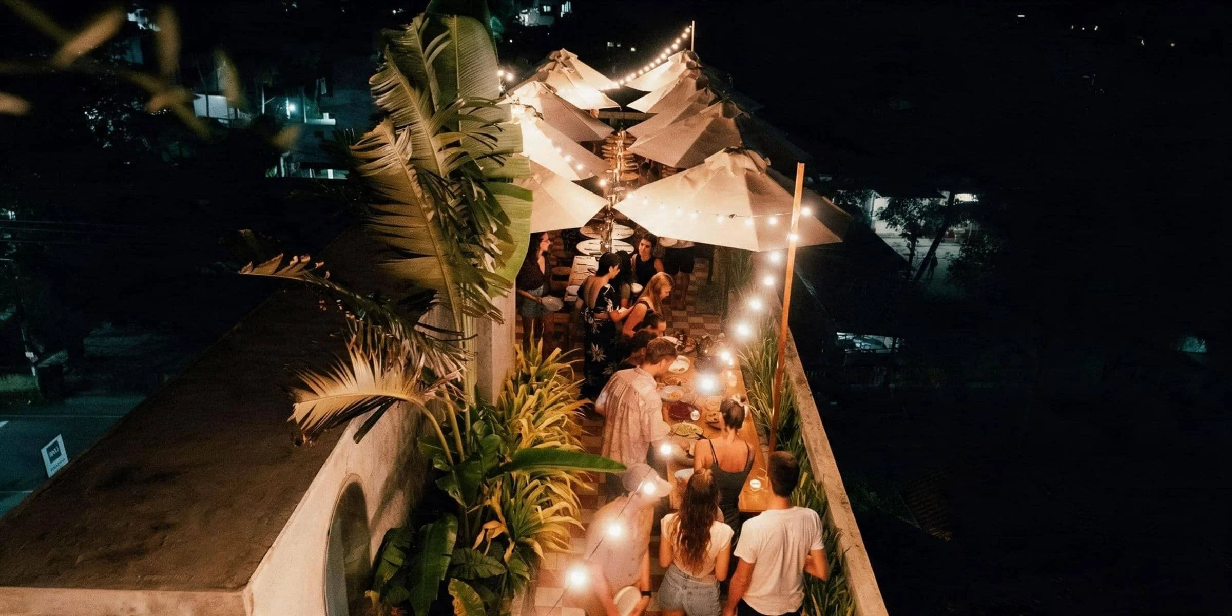 Guests sharing a meal together on Layback's rooftop during a surf and yoga retreat in Weligama