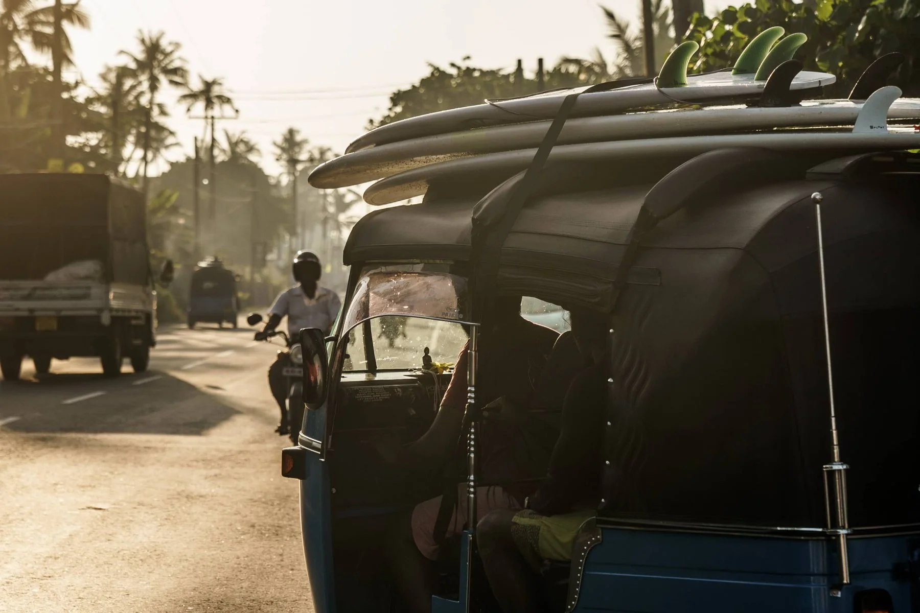 Layback jeep loaded with surfboards heading out for a morning session