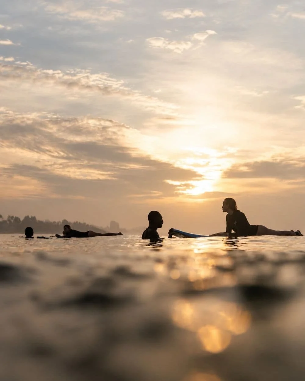 Layback surf coach helping a beginner during a surf lesson in Weligama