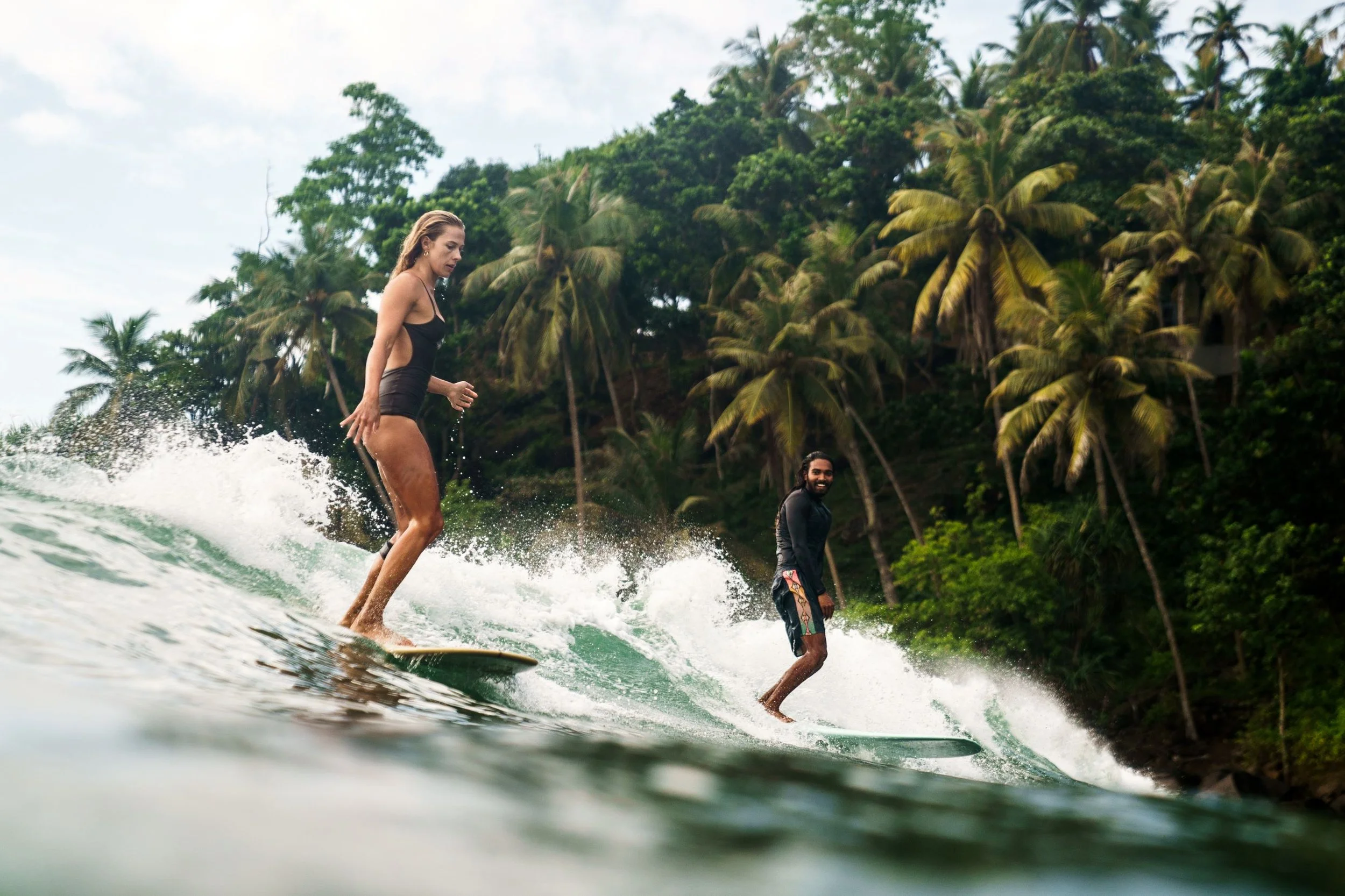 Aerial shot of Sri Lanka's south coast with surfers heading out