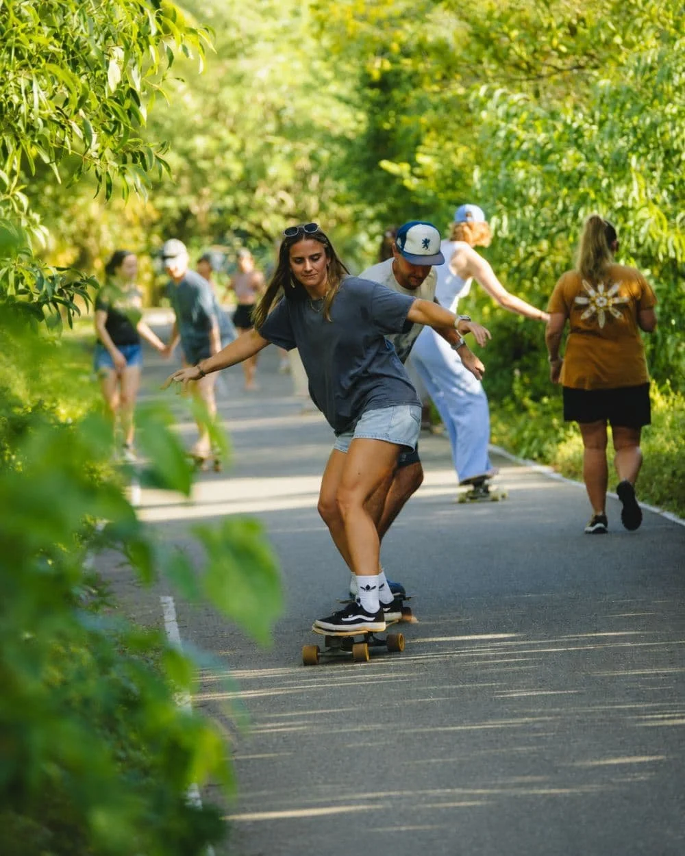 Coach actively correcting an intermediate guest's surfskate movement